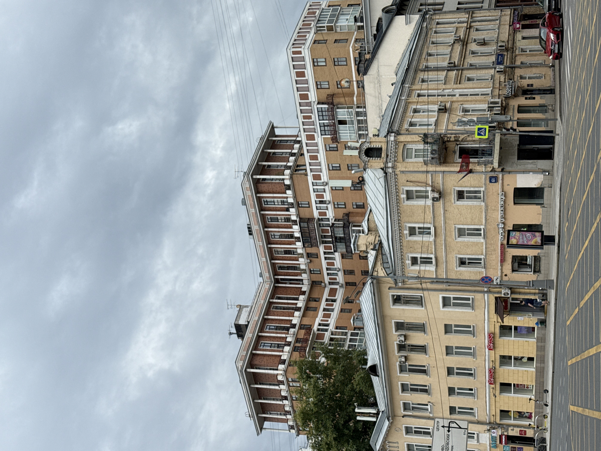 Moscow street corner: scooters, storefronts, and artificial flowers