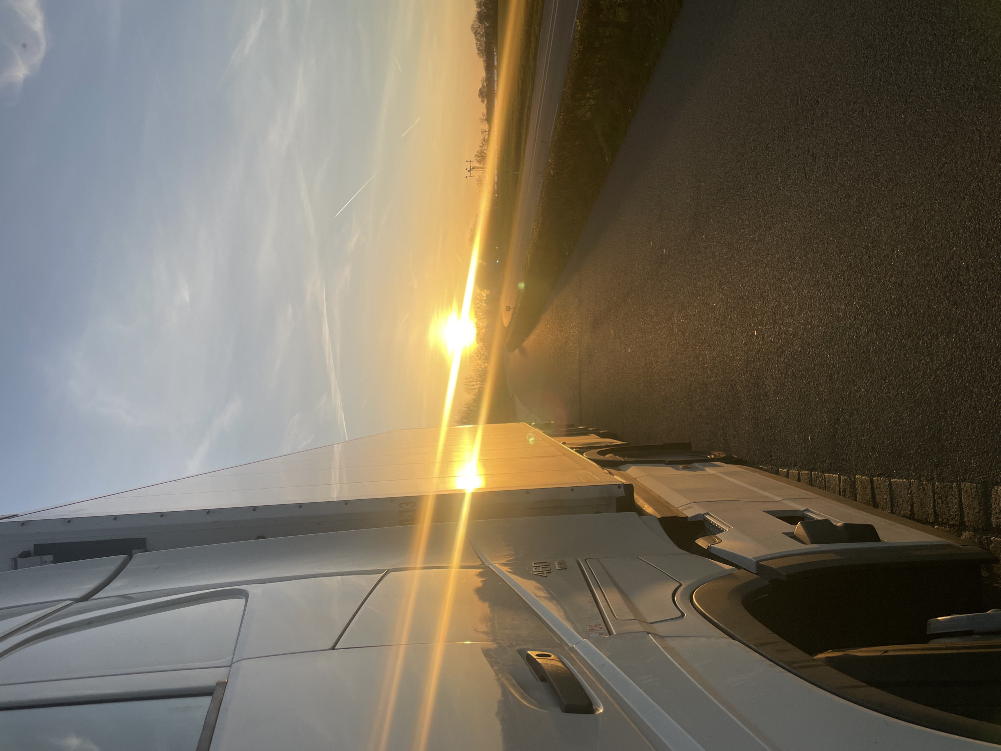 Truck parked roadside in sunlit Volkel, Netherlands evening