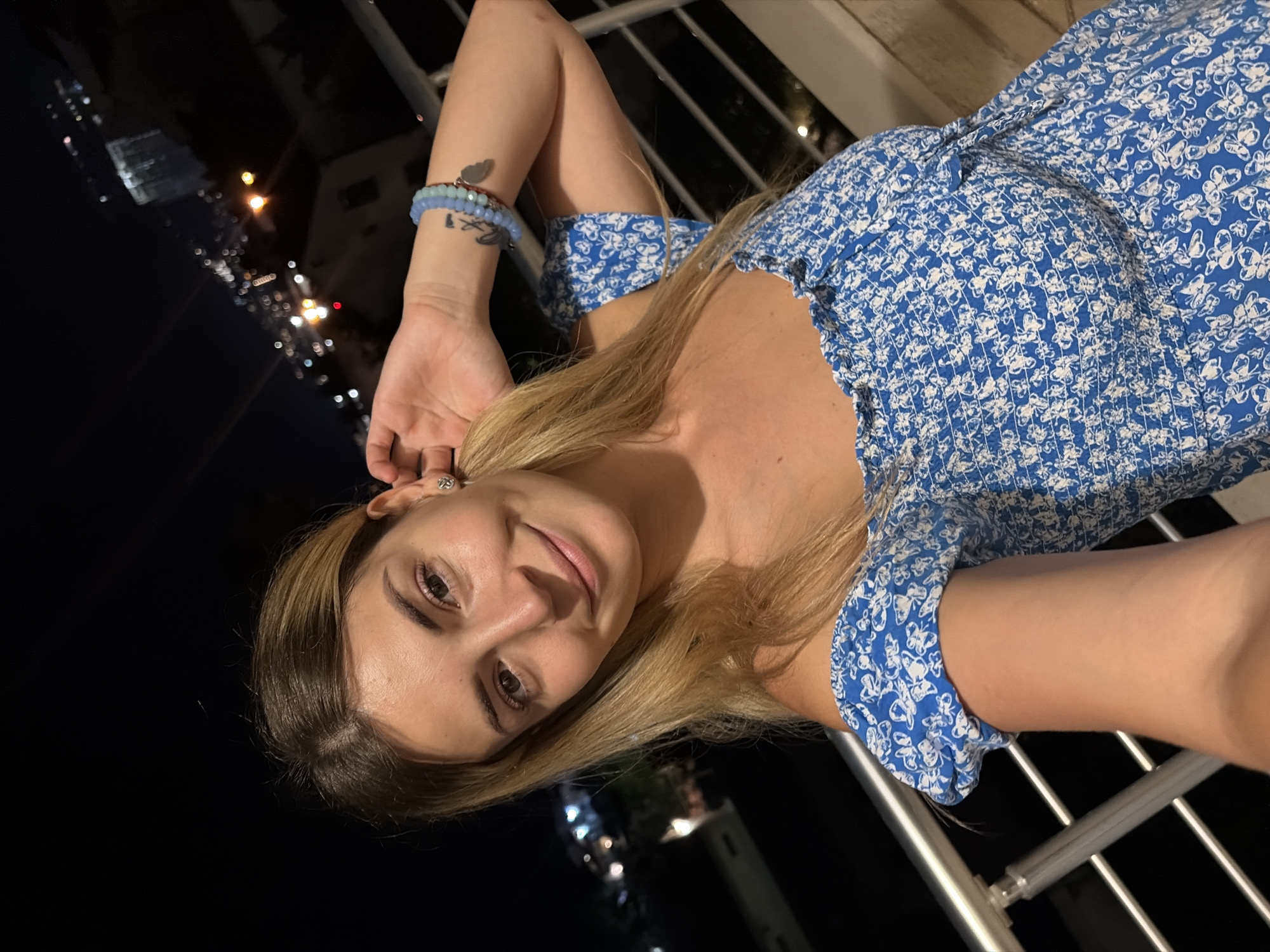 Balcony evening in Budva with city lights and selfies