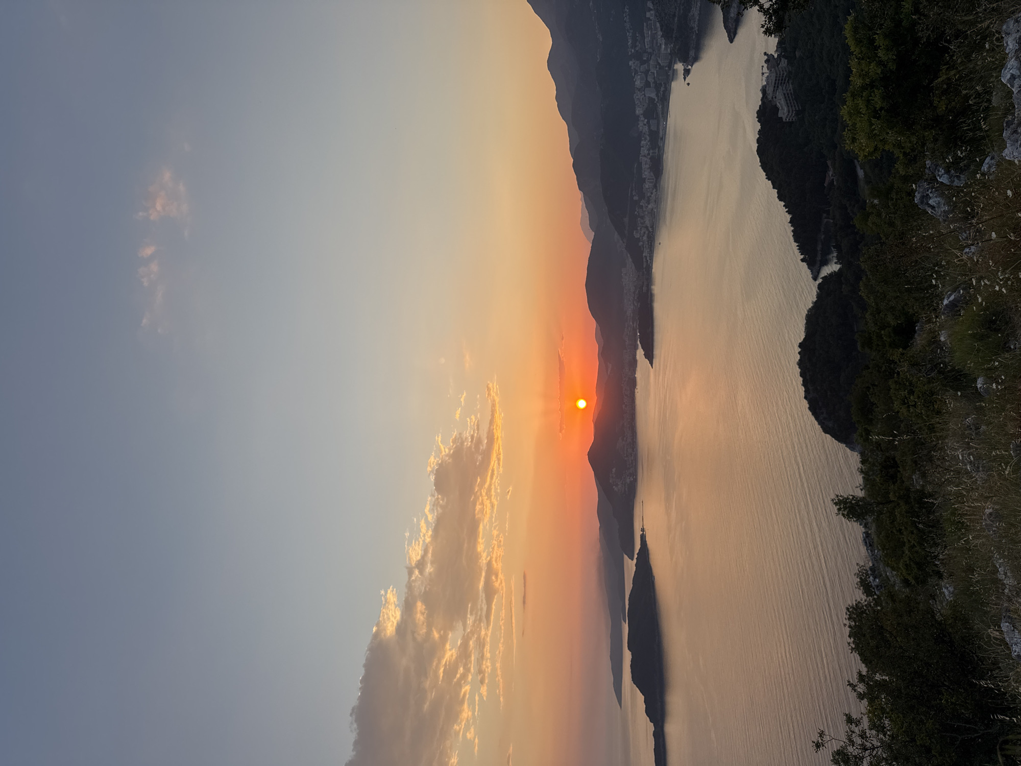 Sunset framed by hand gesture captured in Montenegro