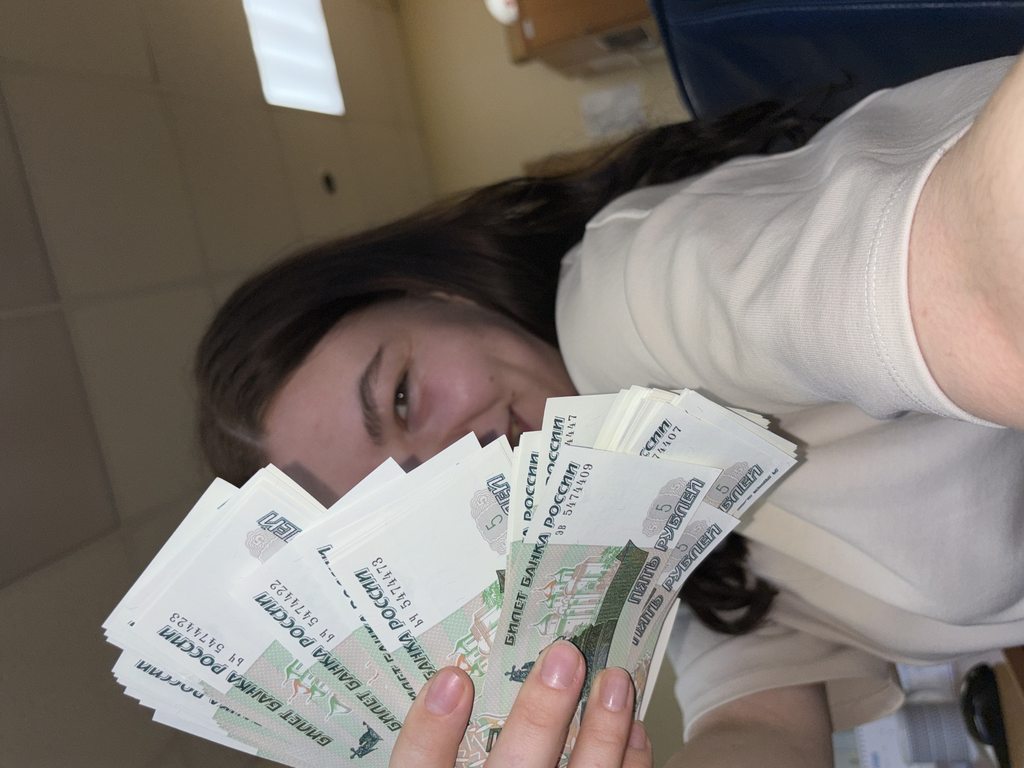 Woman handles Russian rubles in Perm office setting
