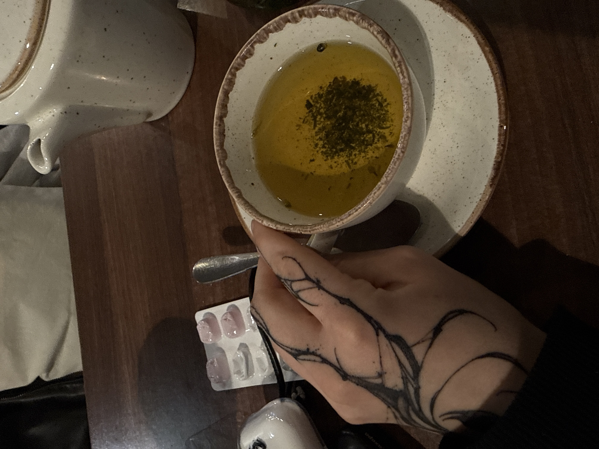 Moscow cafe patron enjoys herbal tea with medication nearby