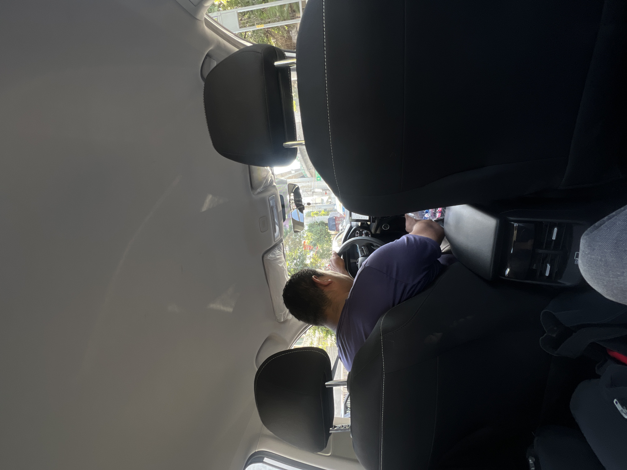 Driver photographed from rear seat in Mexico City vehicle