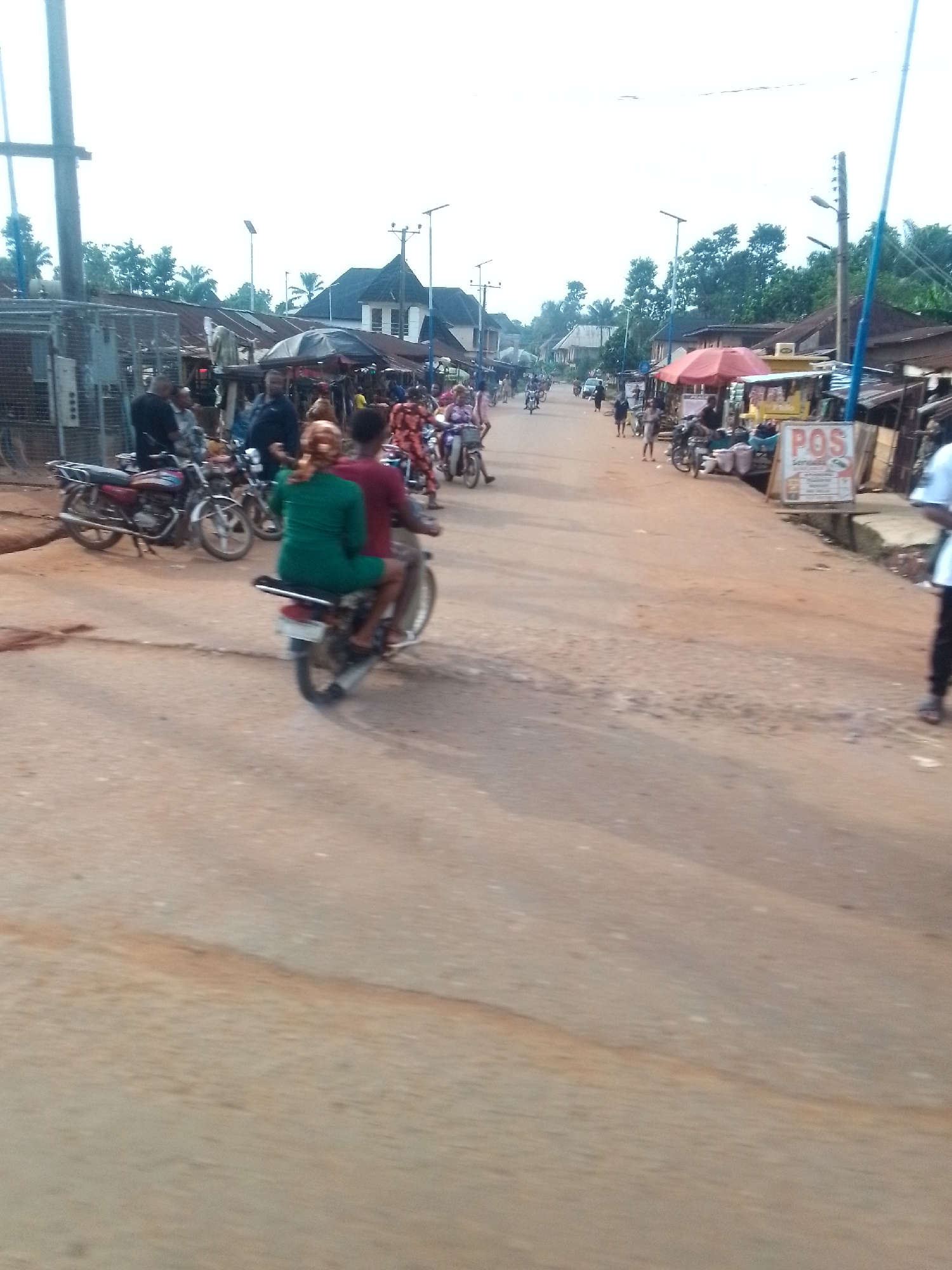 Urban roadside shows major trash accumulation near residential area