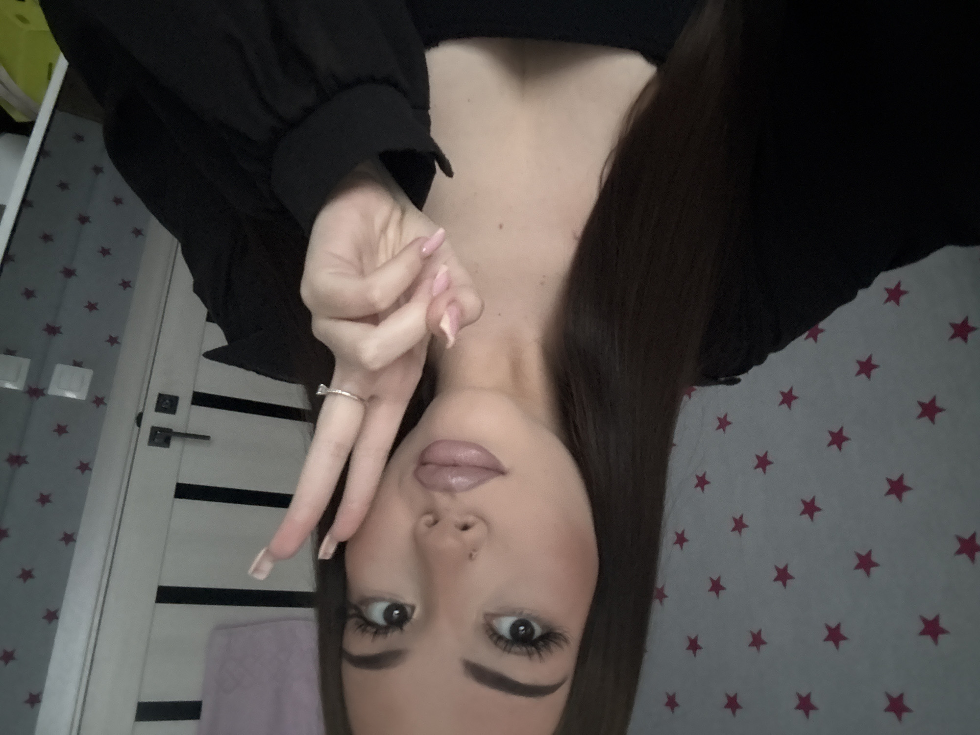 Young woman takes multiple selfies in Russian bedroom