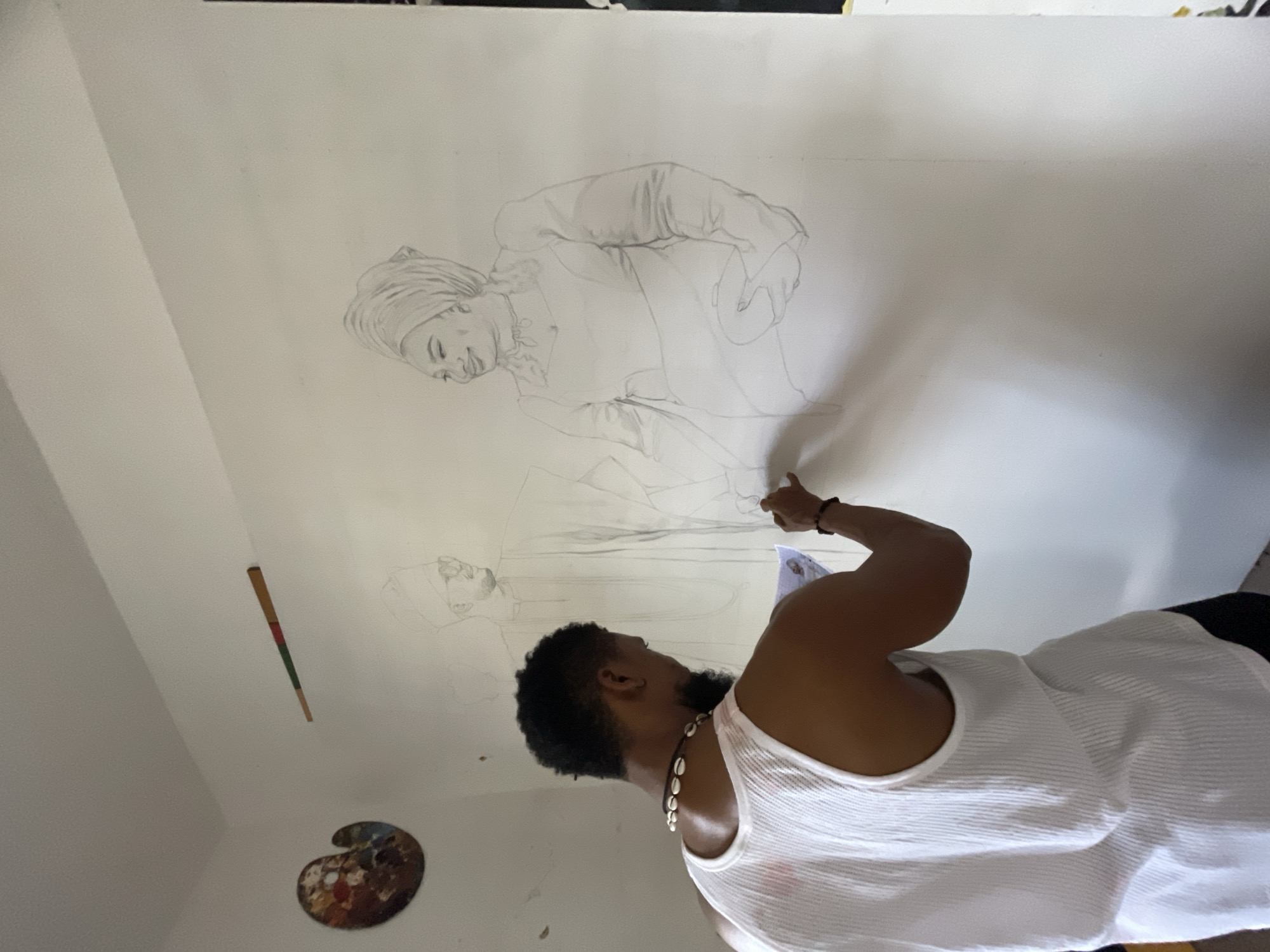 Artist draws figures on paper in Ado, Nigeria