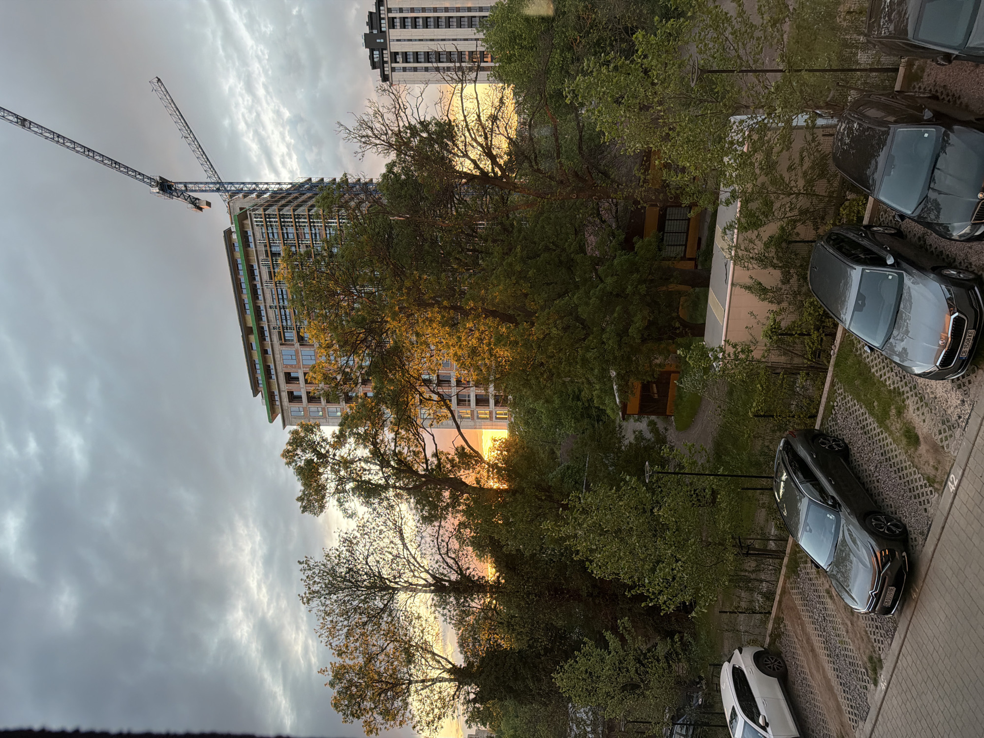 Sunset illuminates dramatic clouds over Sofia construction scene