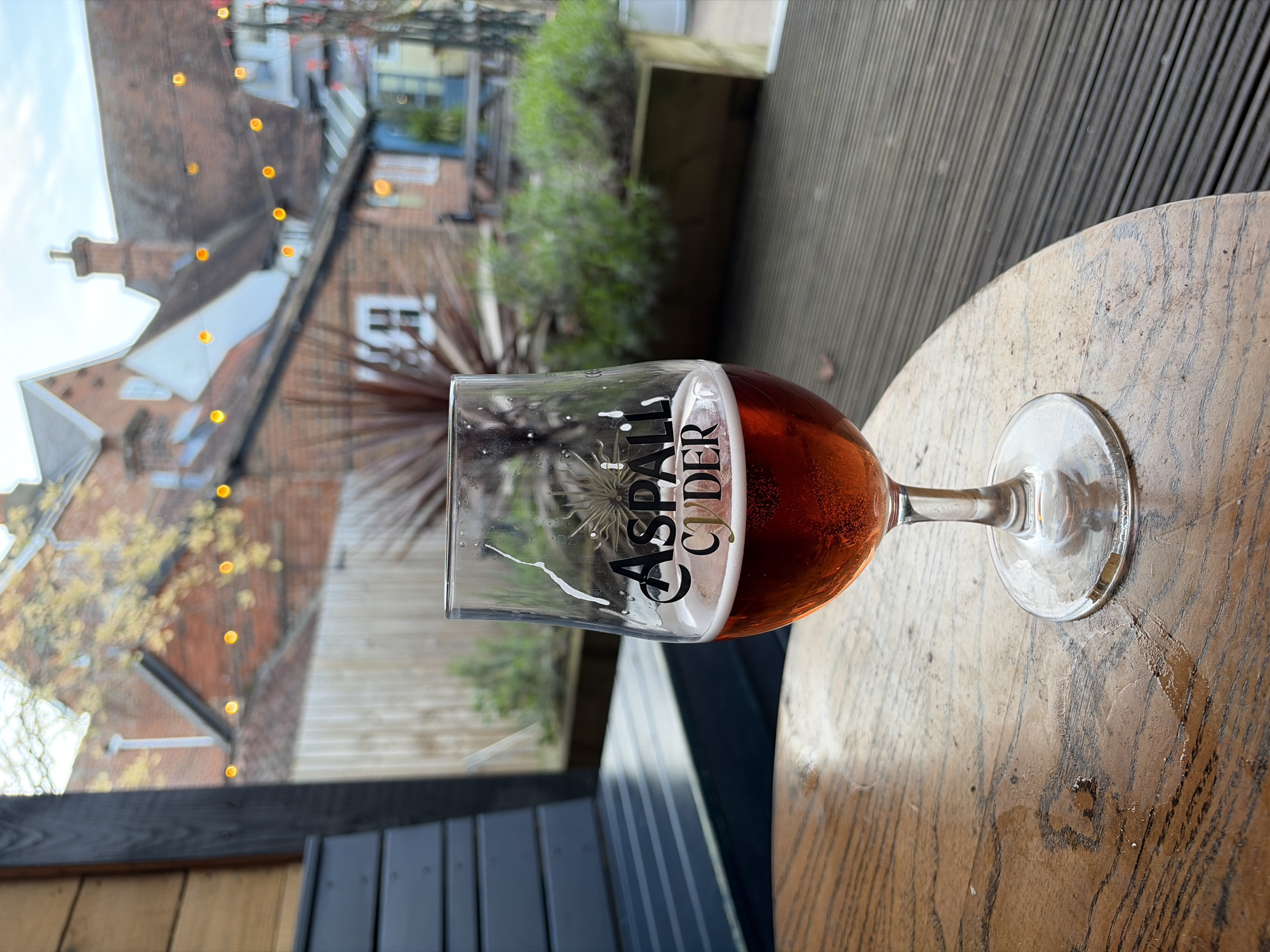 Half-full glass of Aspall Cider observed in East Suffolk