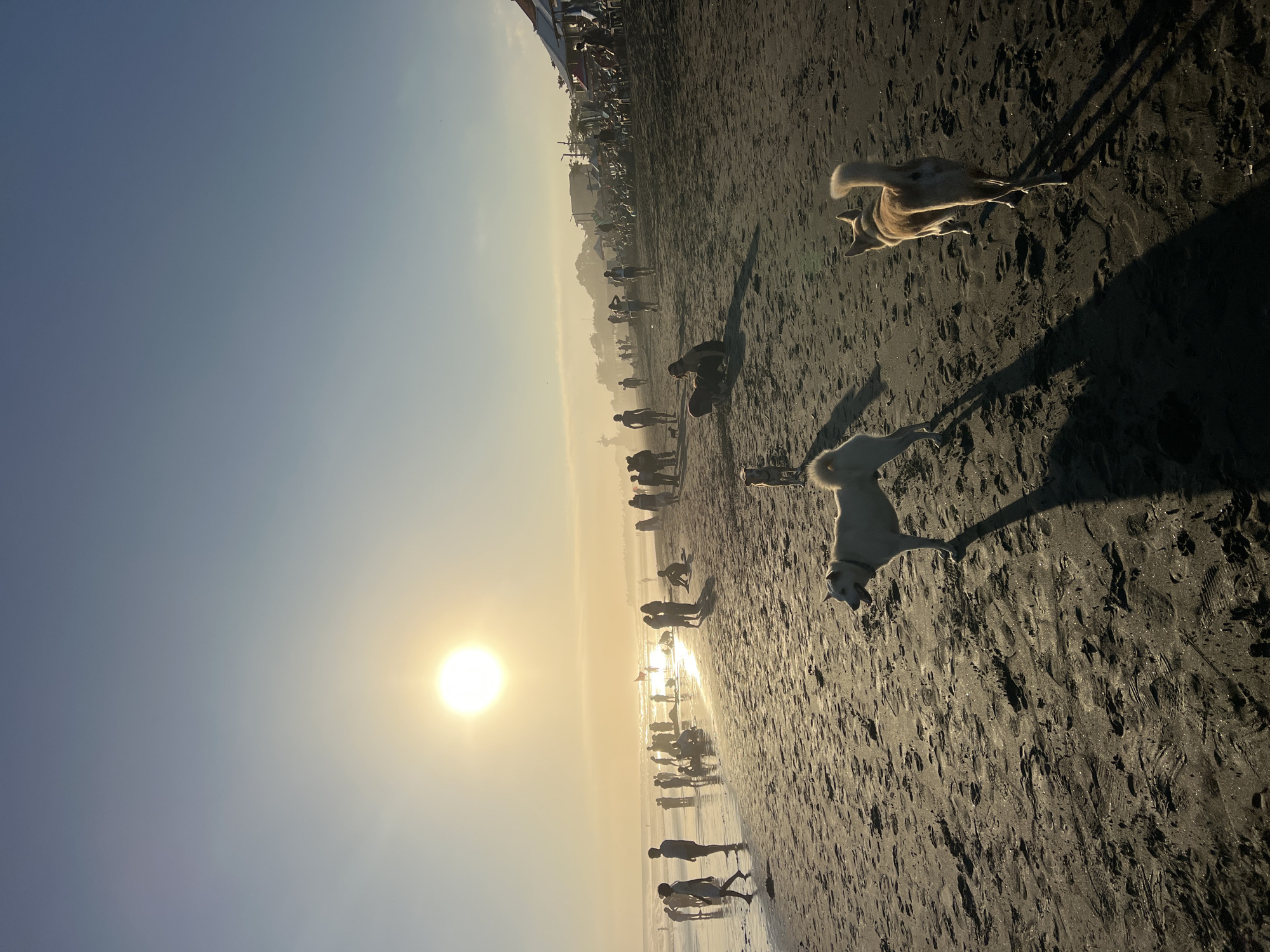 Kuta Beach at golden hour — surf, soccer, and crowds