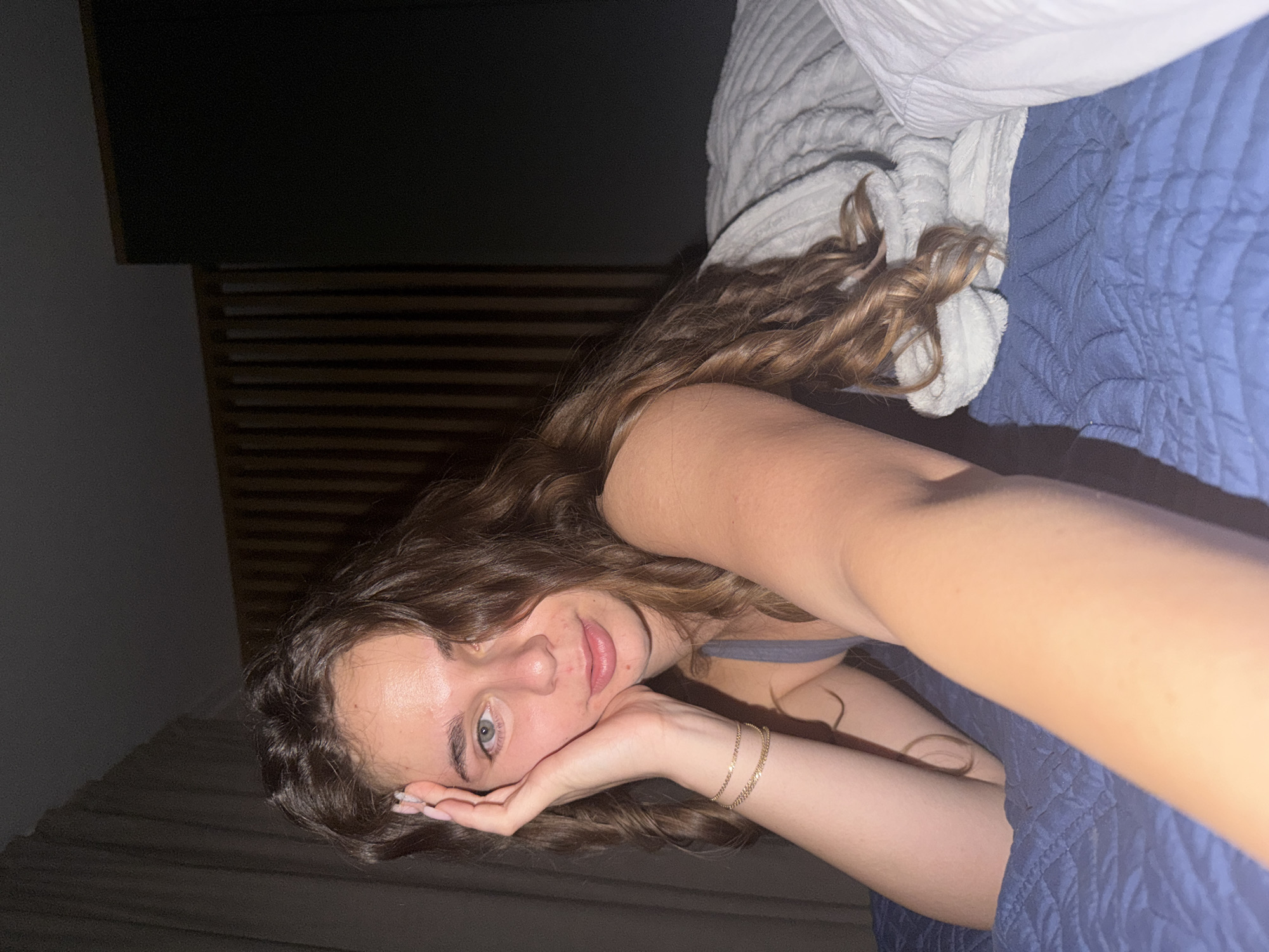 Bedroom selfie series on a blue quilted bed
