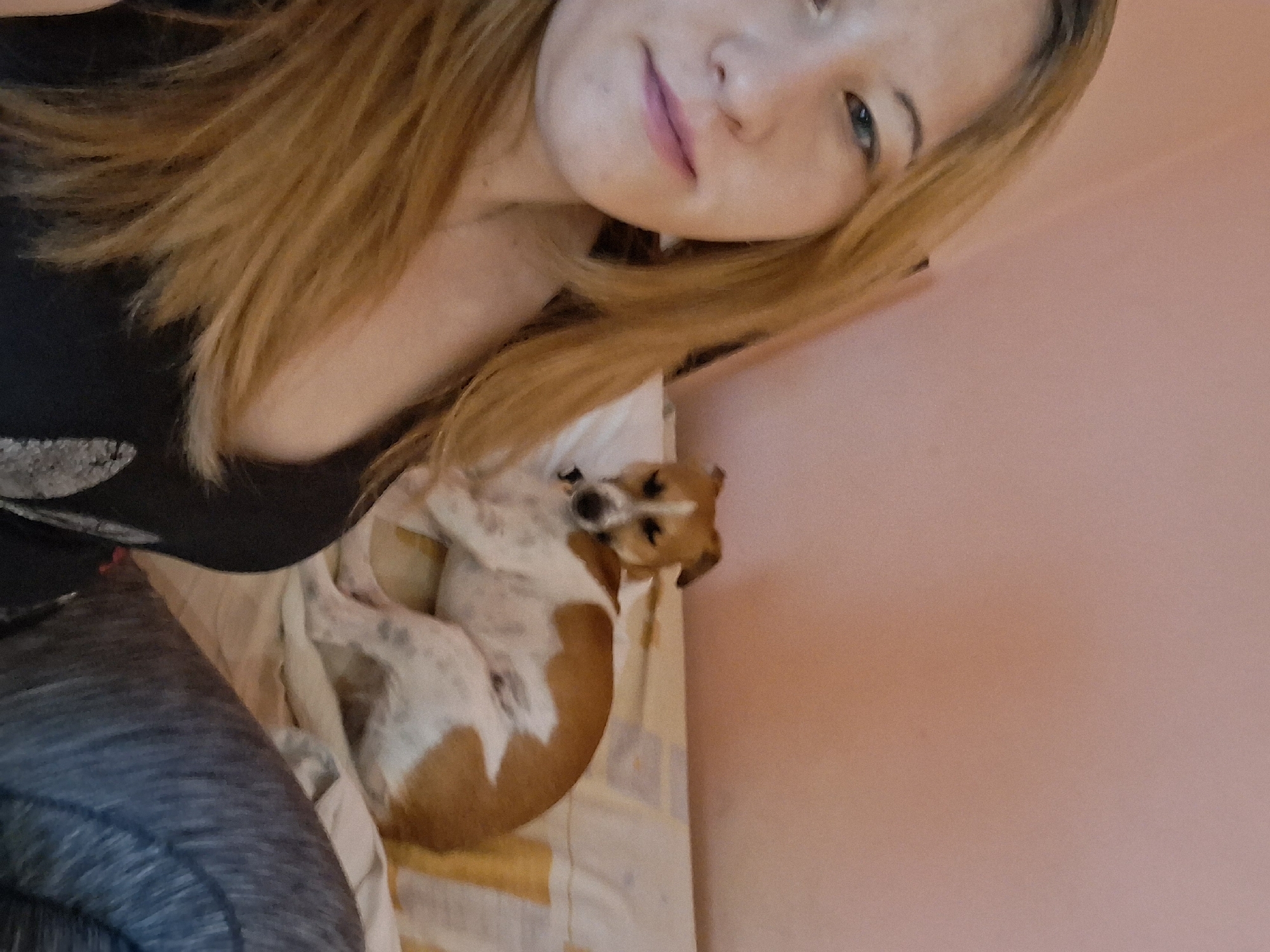 Woman takes early morning selfie with sleeping dog in Bulgaria
