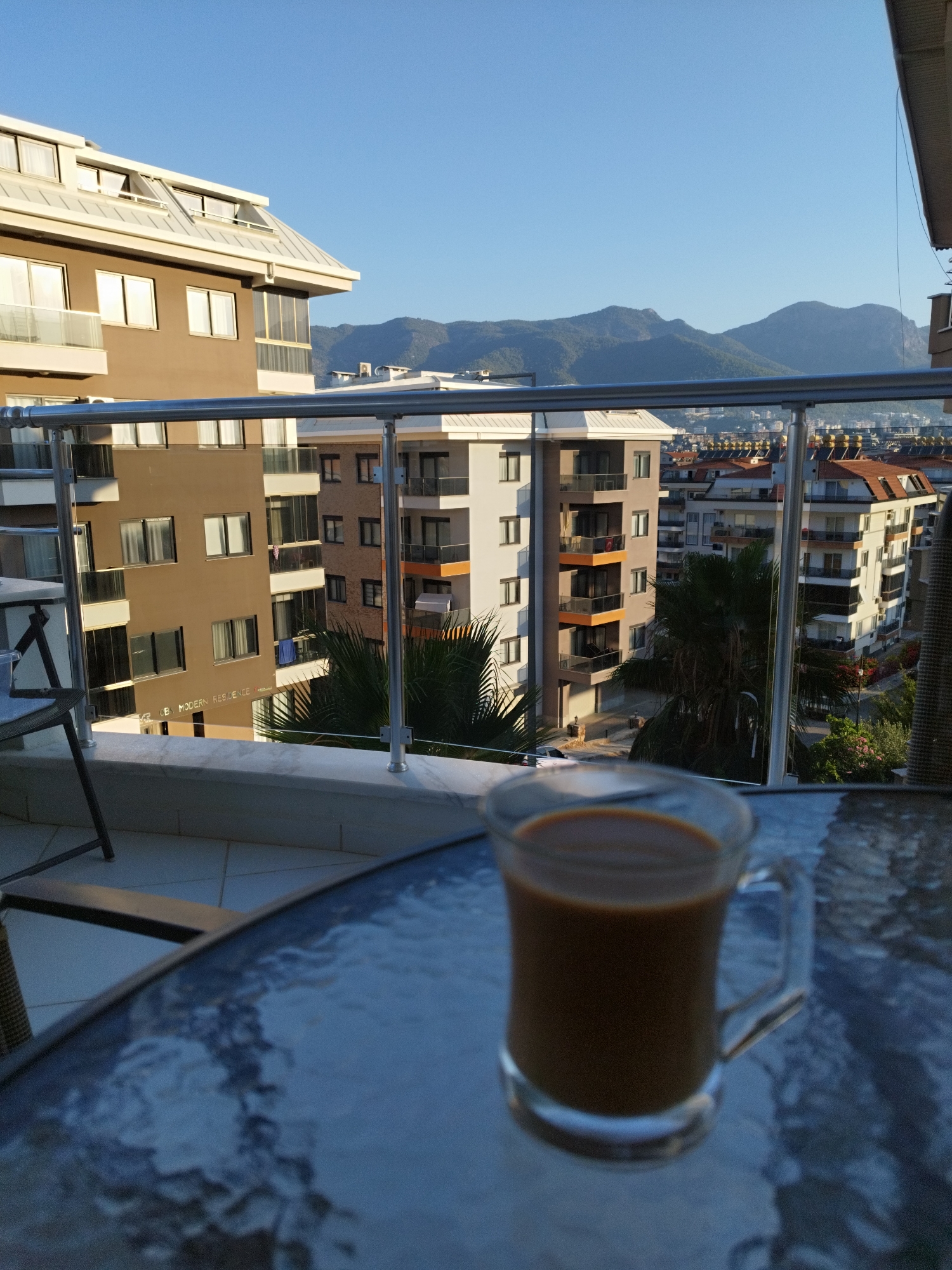 Coffee on a balcony overlooking Alanya's apartment skyline