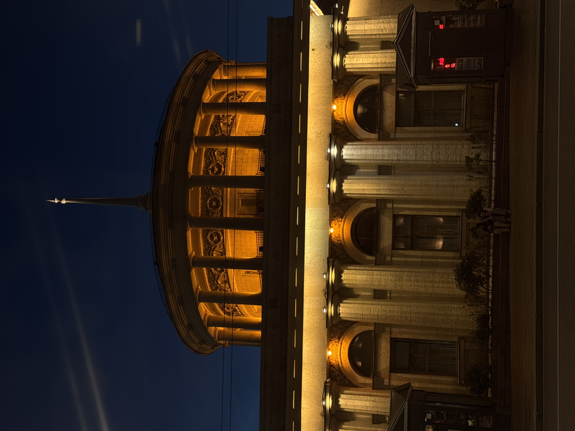 Saint Petersburg landmarks glow at night: Singer House and Alexander Column