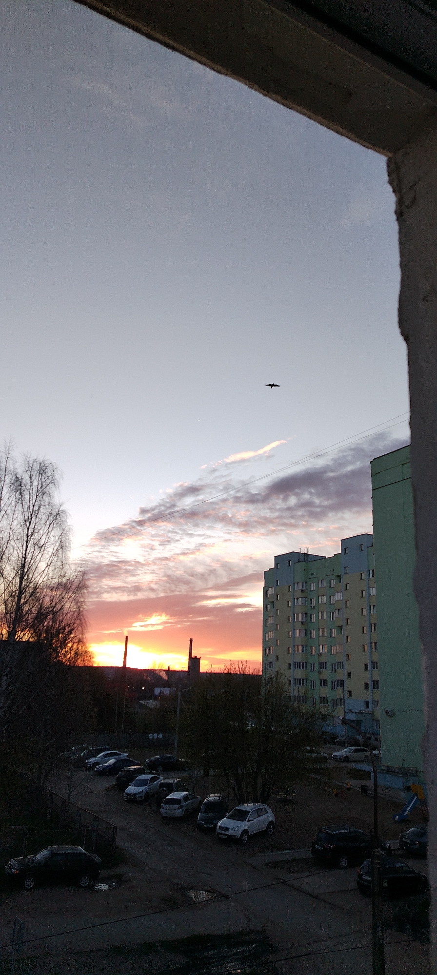 Urban sunset documented across city skyline with industrial backdrop