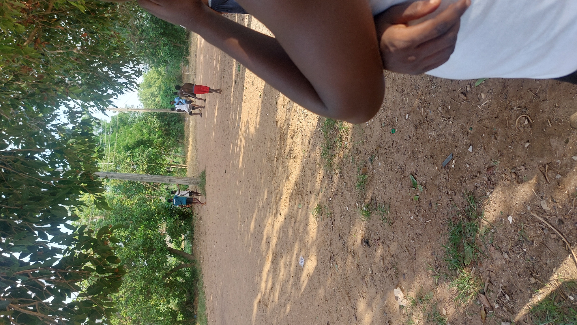 Pickup soccer on a dirt field in New Nyanya, Nigeria