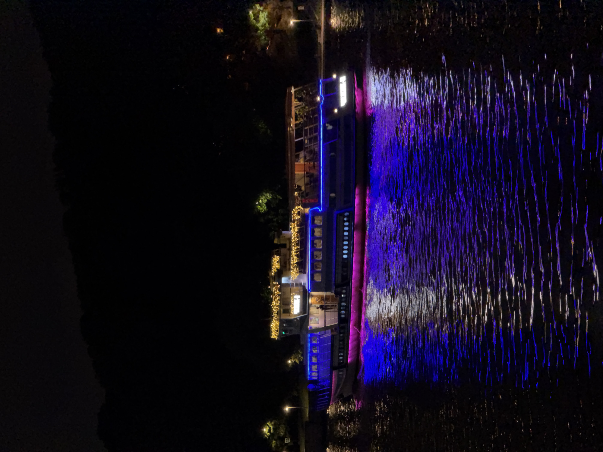 Evening stroll near illuminated passenger ship in Moscow
