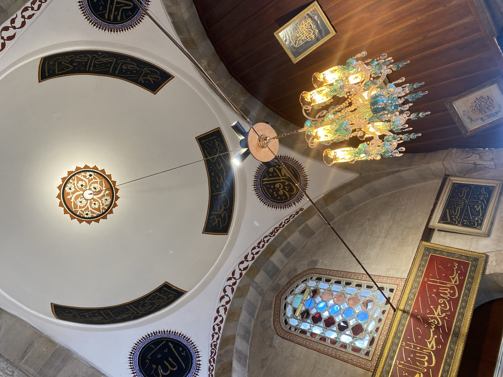Visitor documents historic Karatay Madrasa architecture and Islamic artifacts