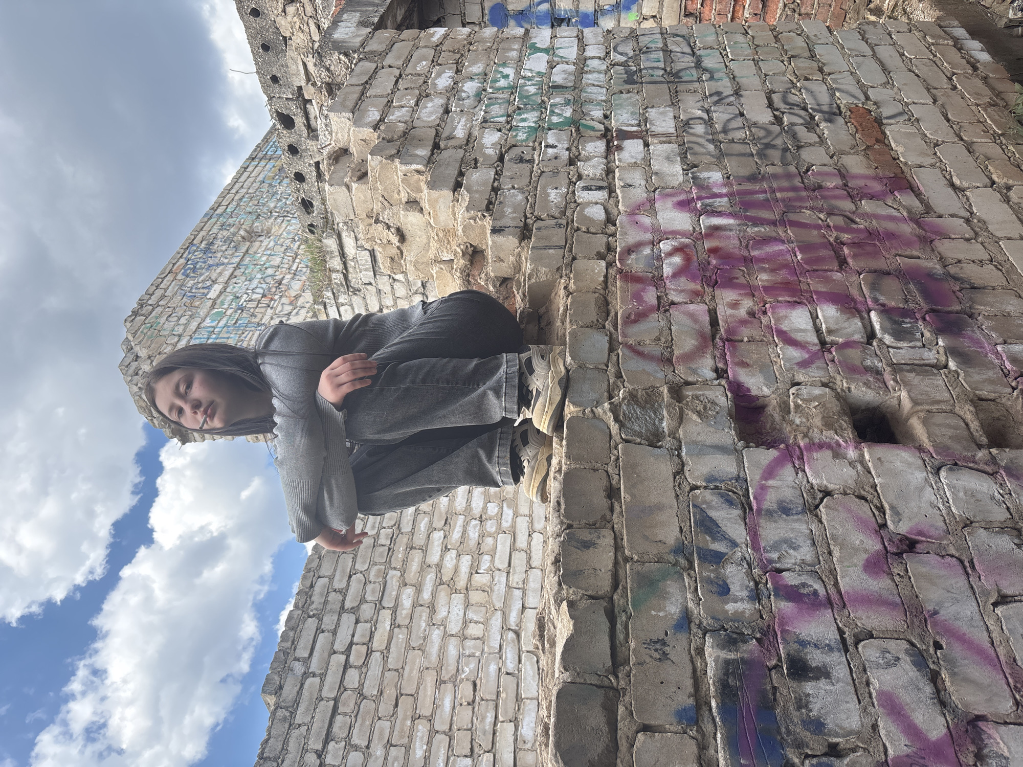 Woman spotted on graffitied ruins in Фоки, Russia