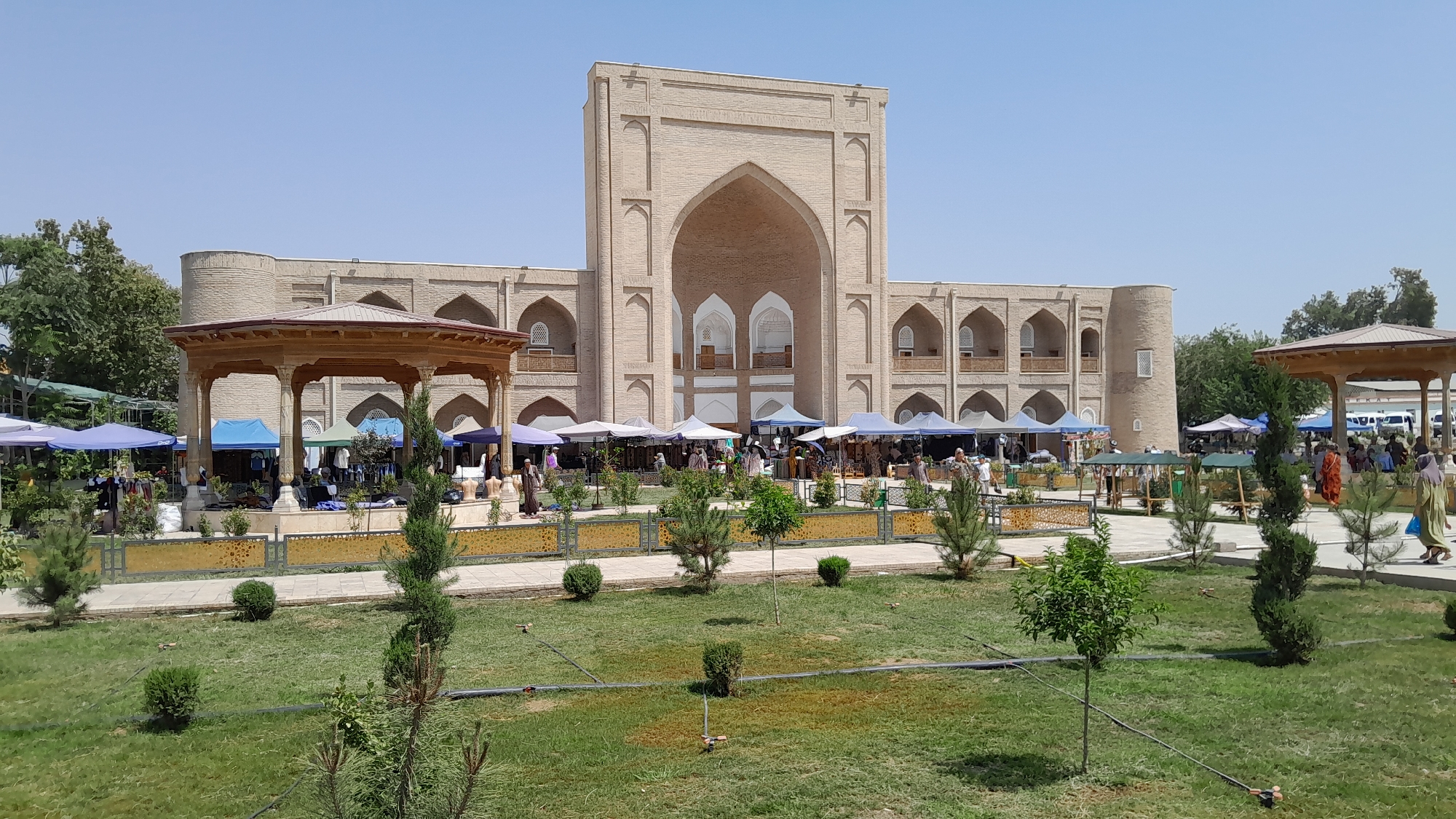 Street market buzzing outside Denov's historic Juma Mosque complex