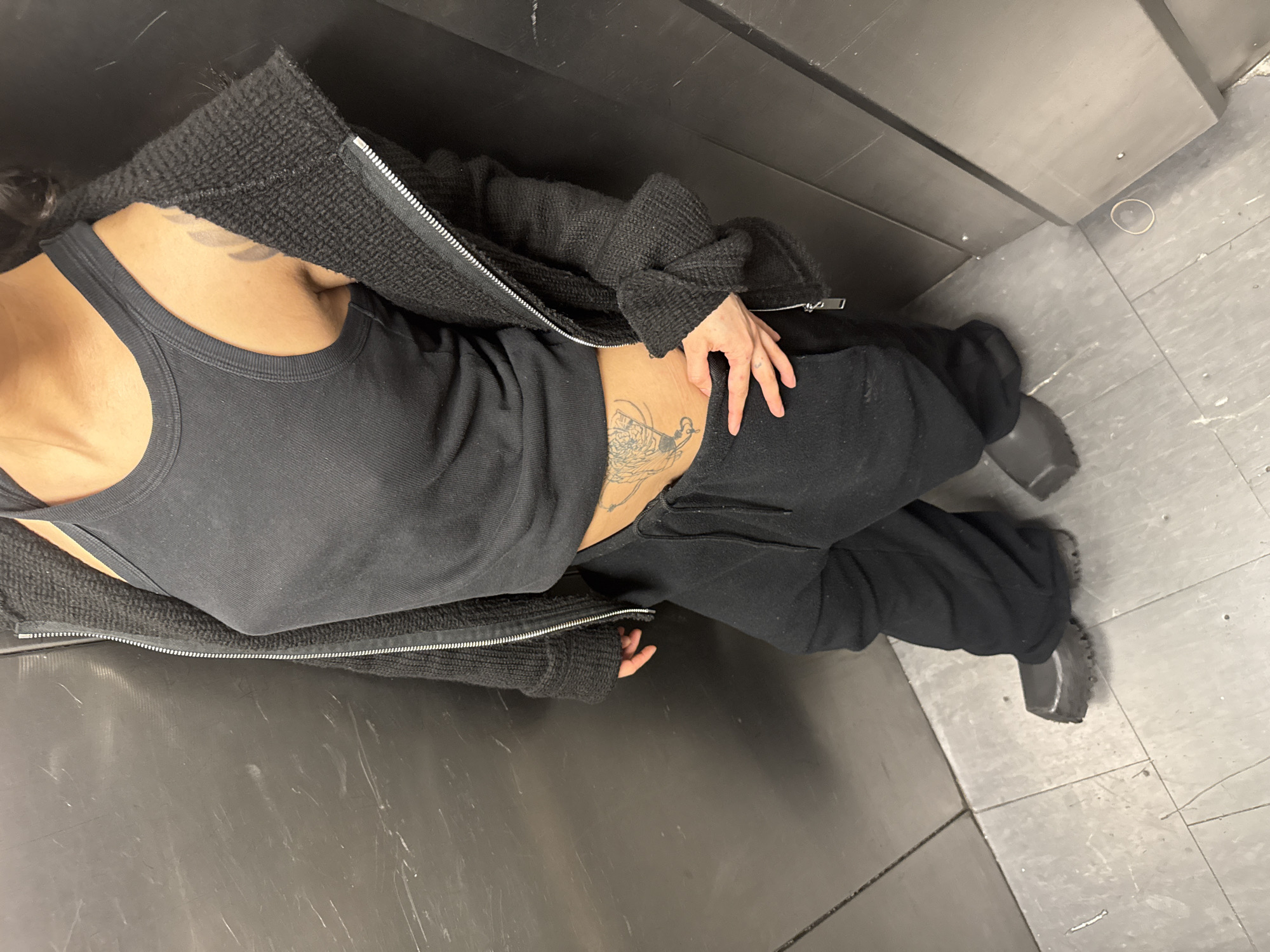 Tattooed individual in black clothing observed lying in London