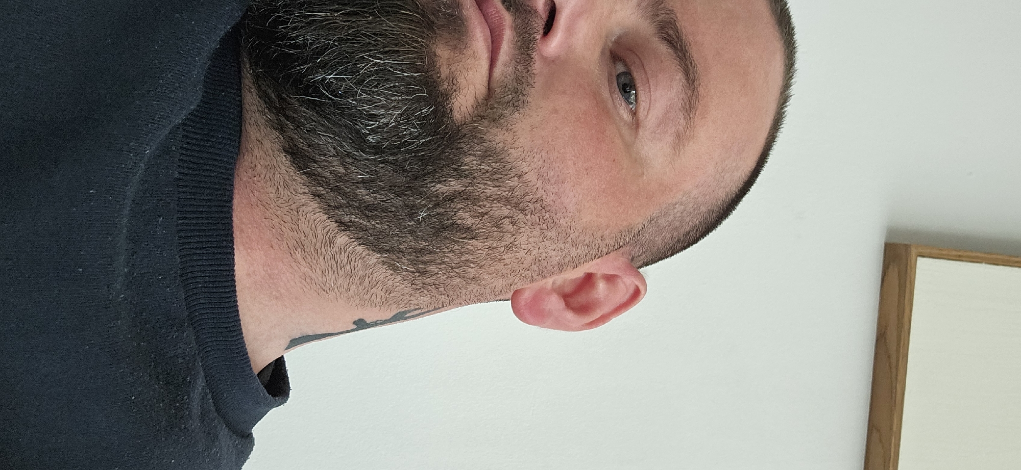 Portrait of bearded man photographed indoors in Gütersloh