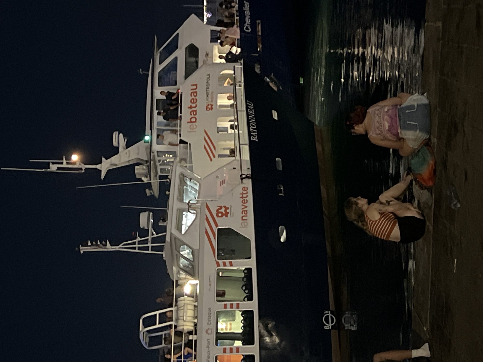 Métropole ferry docked at Marseille's illuminated Old Port at night