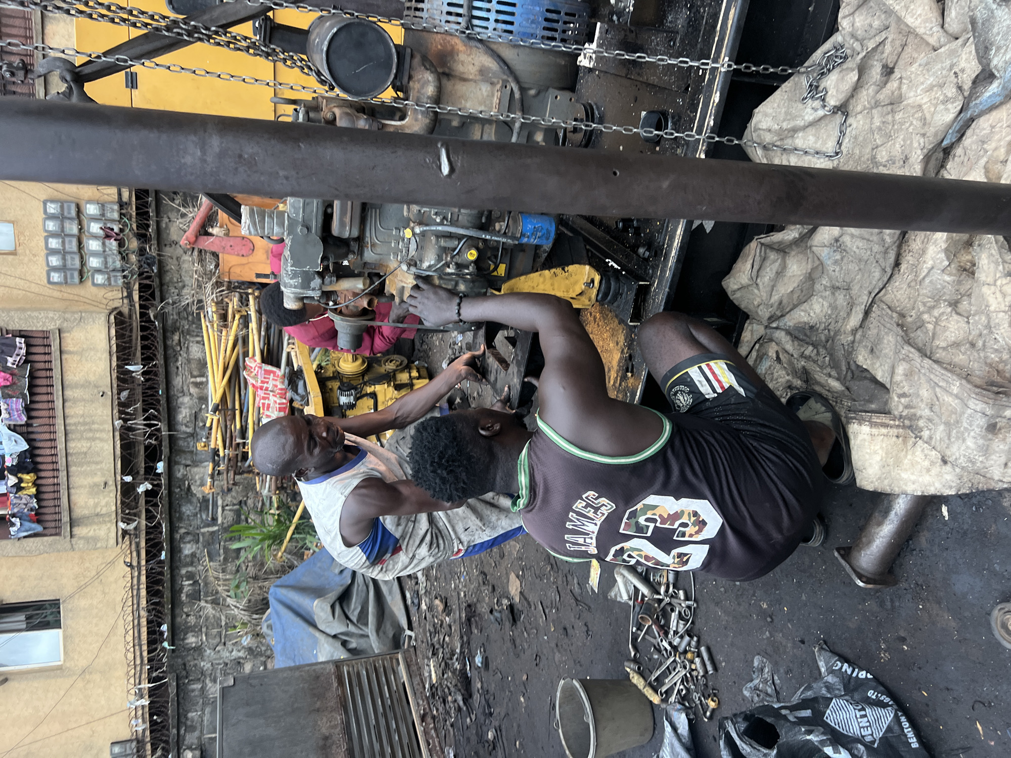 Generator repair work underway at outdoor workshop in Obosi, Nigeria