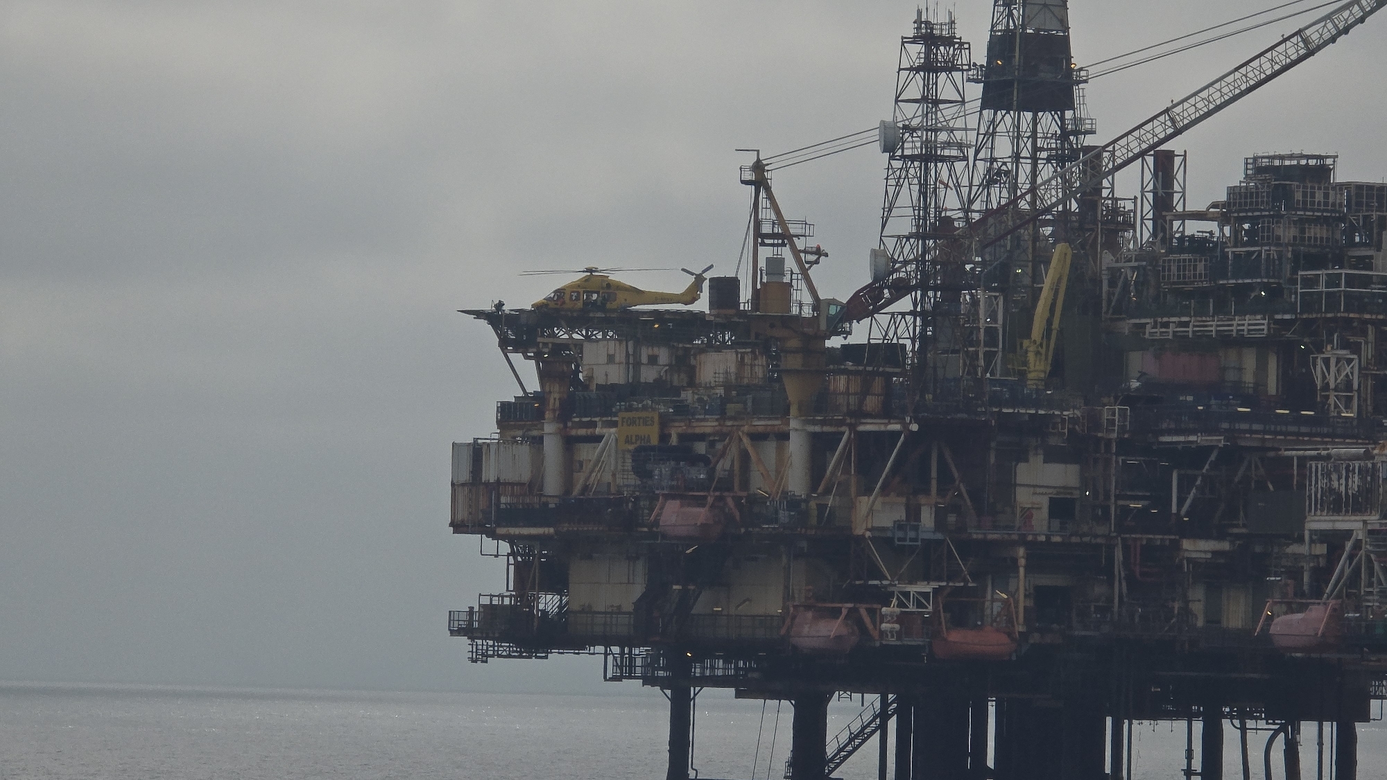 Helicopter landing at Forties Alpha oil rig, North Sea