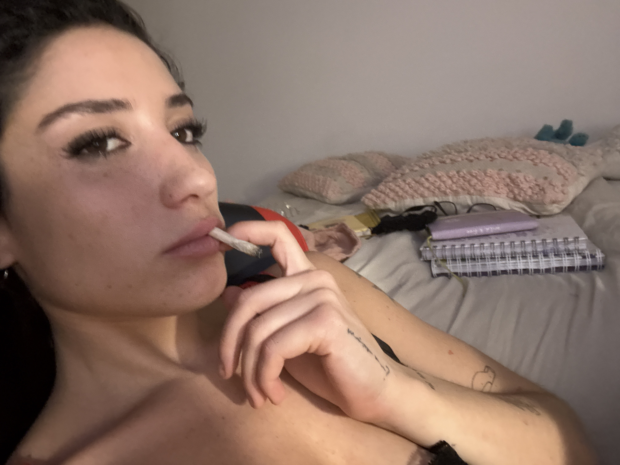 Woman smoking cigarette on bed in Buenos Aires