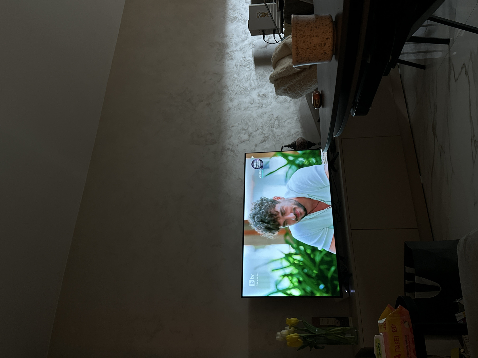 Person relaxes at home with smartphone in Sofia