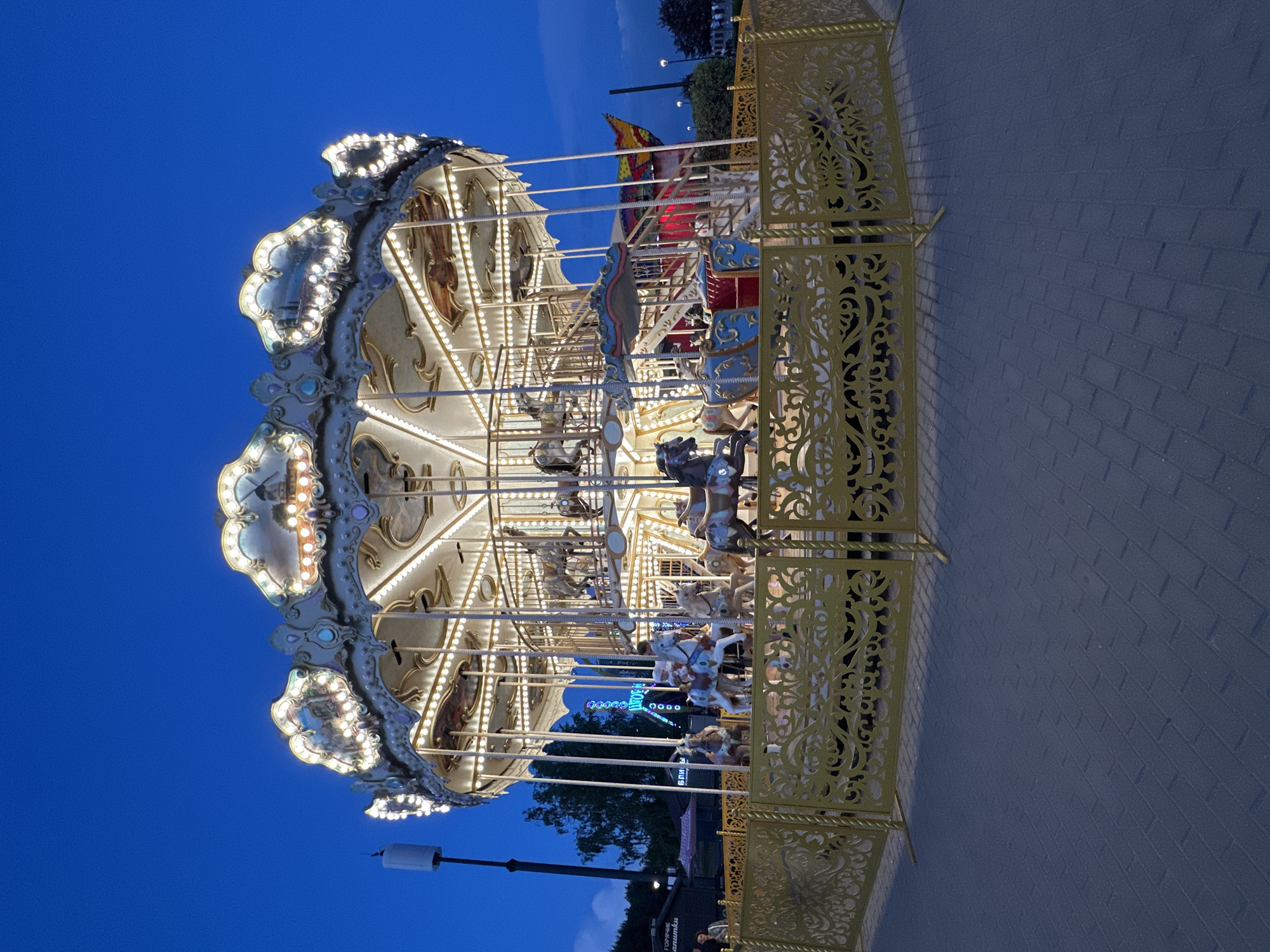 Ornate carousel spins at dusk in Novosibirsk