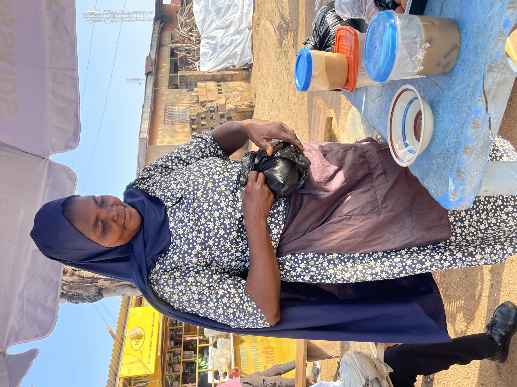 Morning food vendor serves customers at Jos market stall