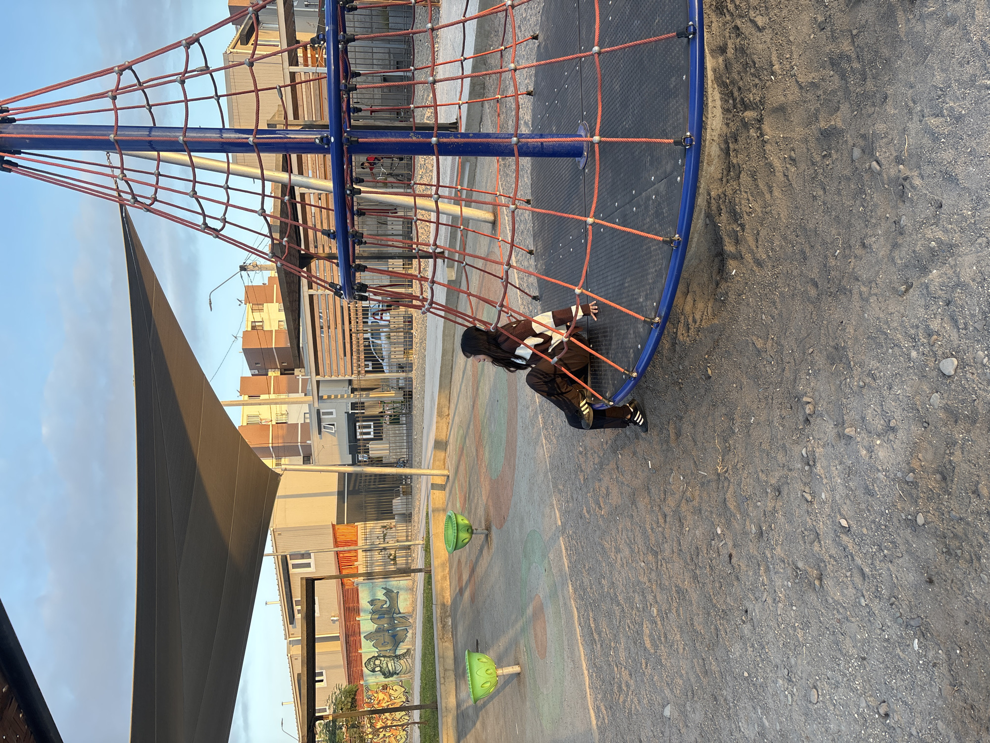 Child plays at Arica playground during golden hour sunset