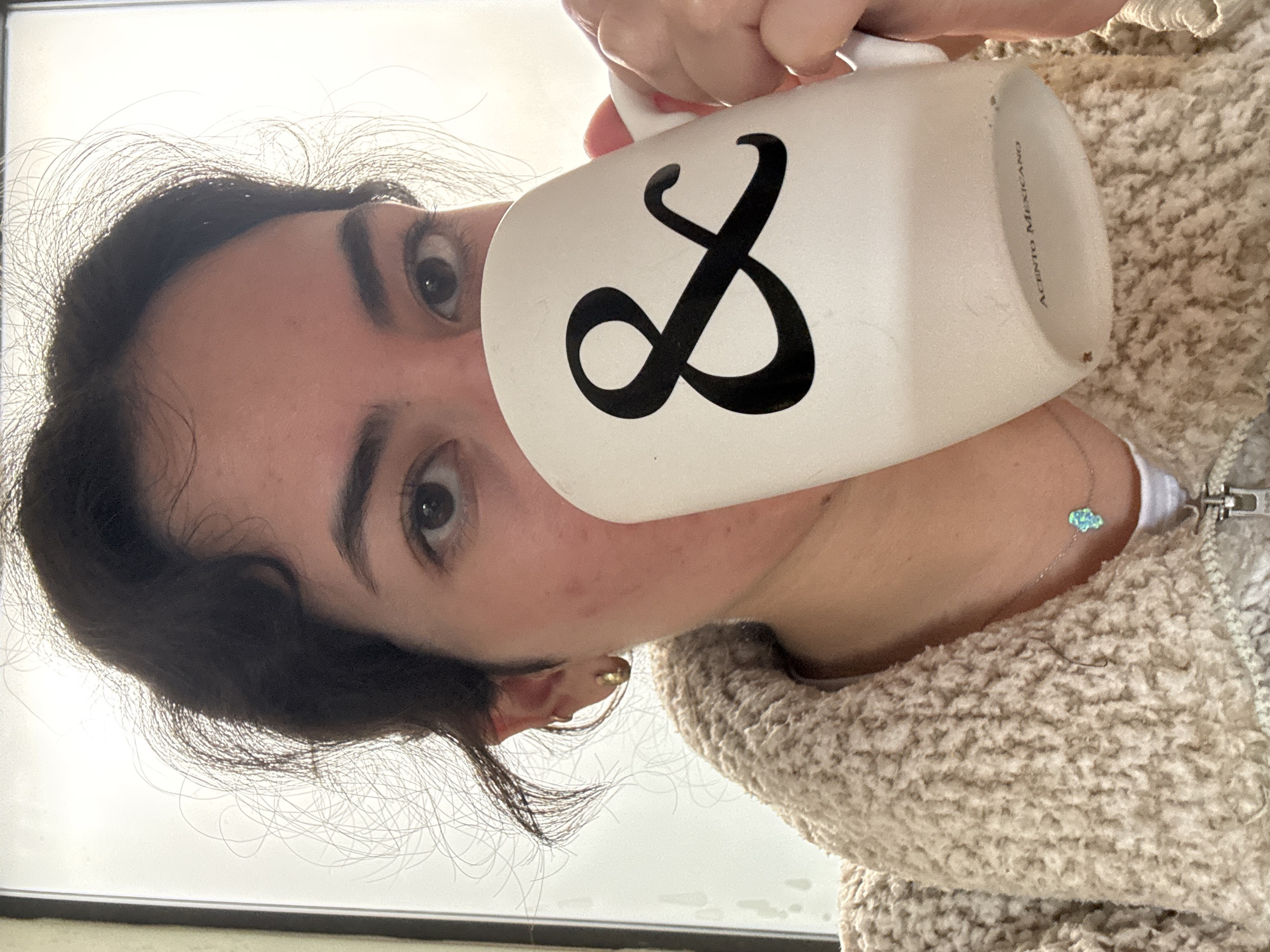 Woman drinks from mug and juice, reacts negatively in Puebla kitchen
