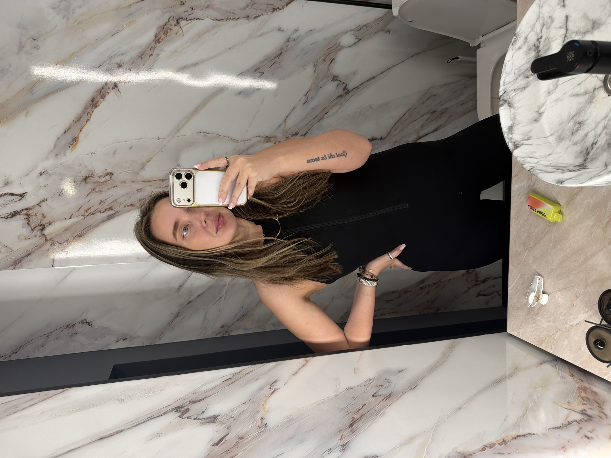 Woman takes bathroom mirror selfies in Moscow marble restroom