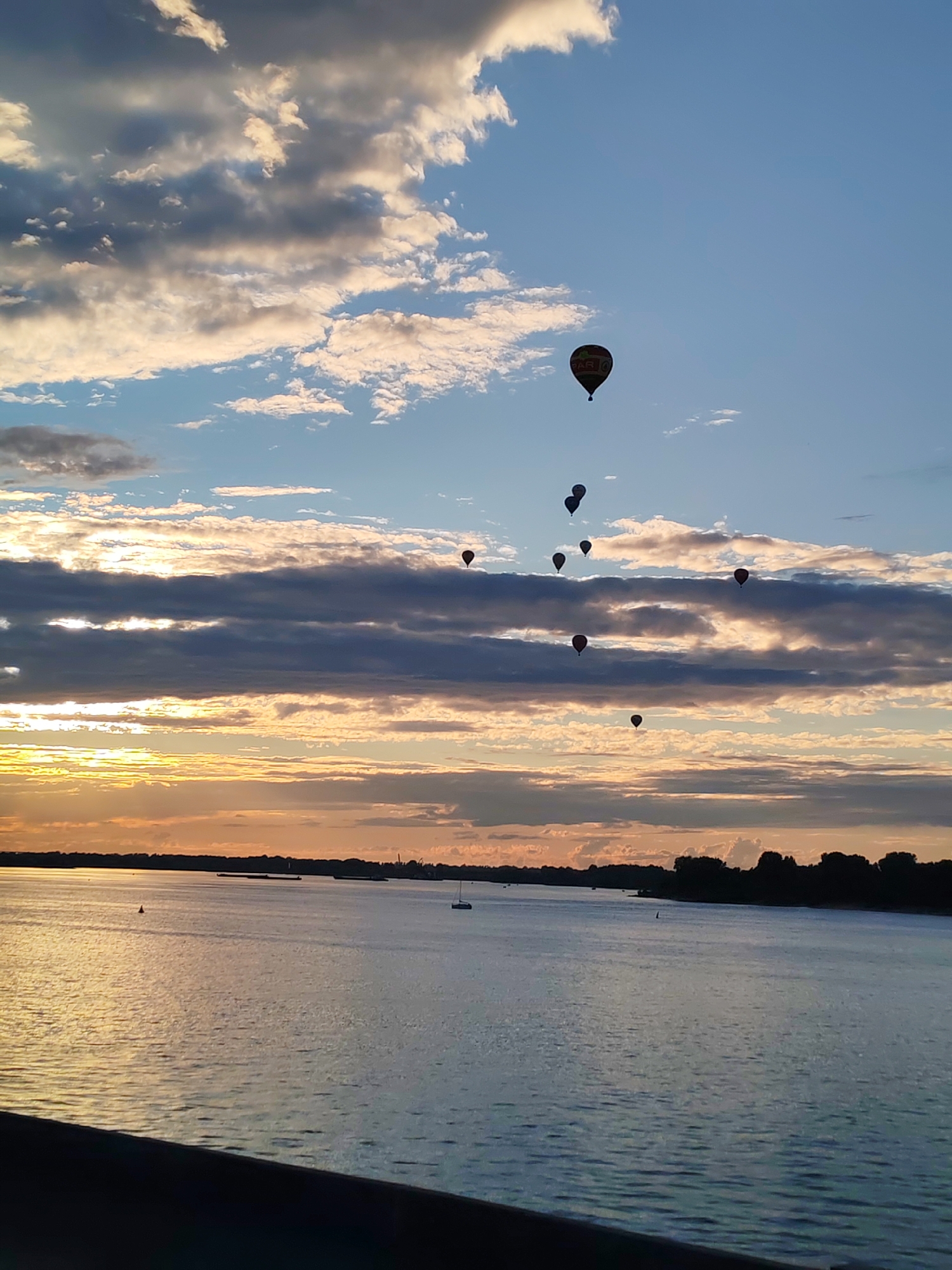 Sunset stroll along the Volga with hot air balloons overhead
