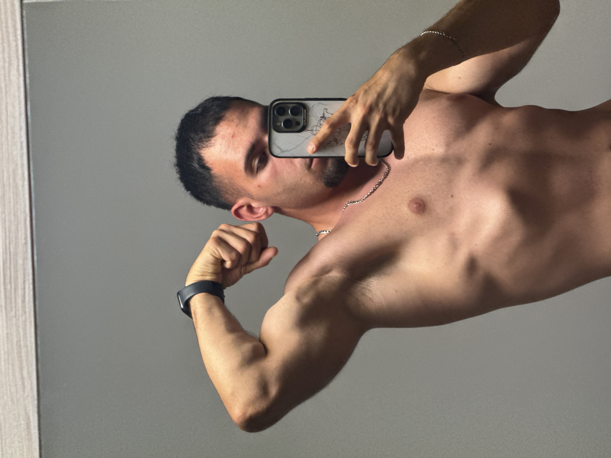 Mirror selfie session in a Shumen bedroom, flexing poses.