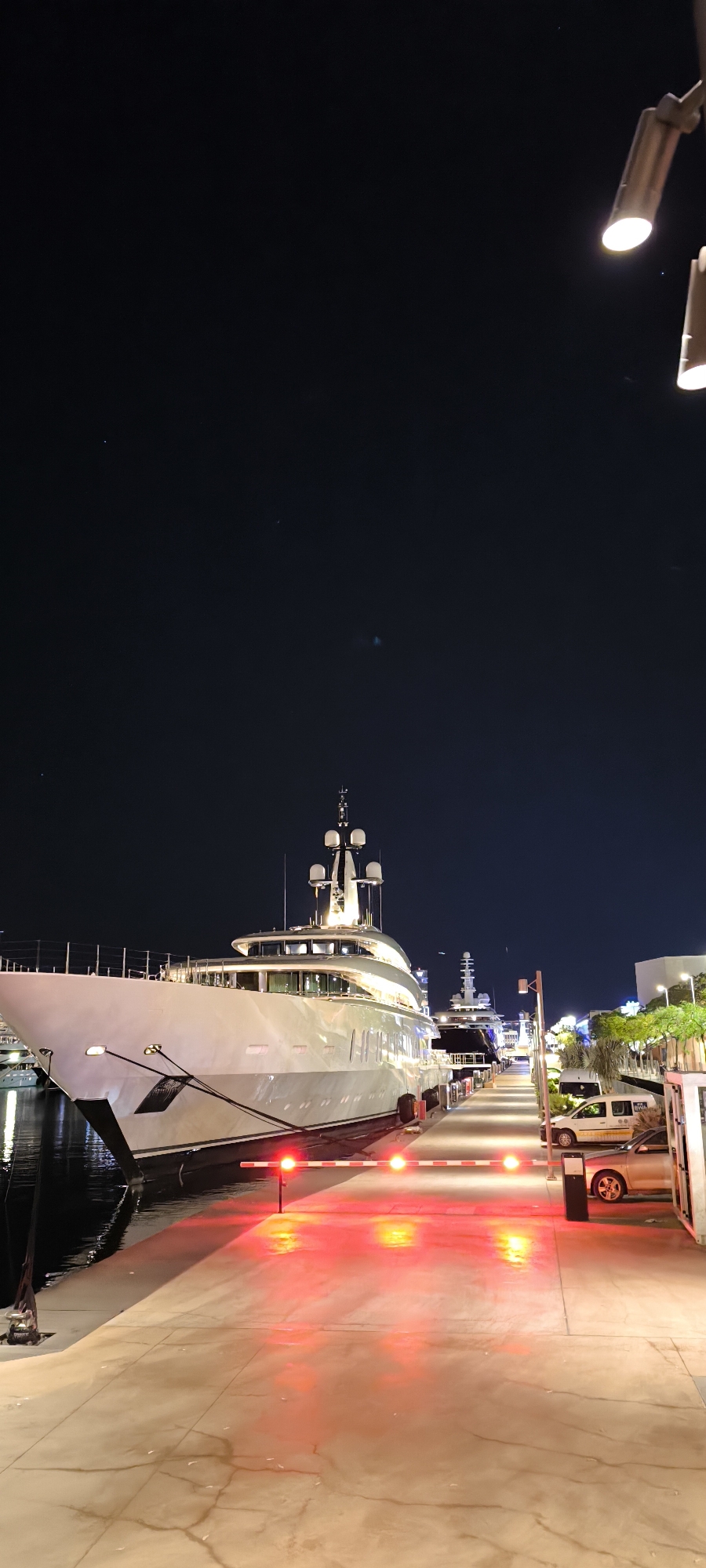 Luxury yacht docked at Barcelona marina during evening hours