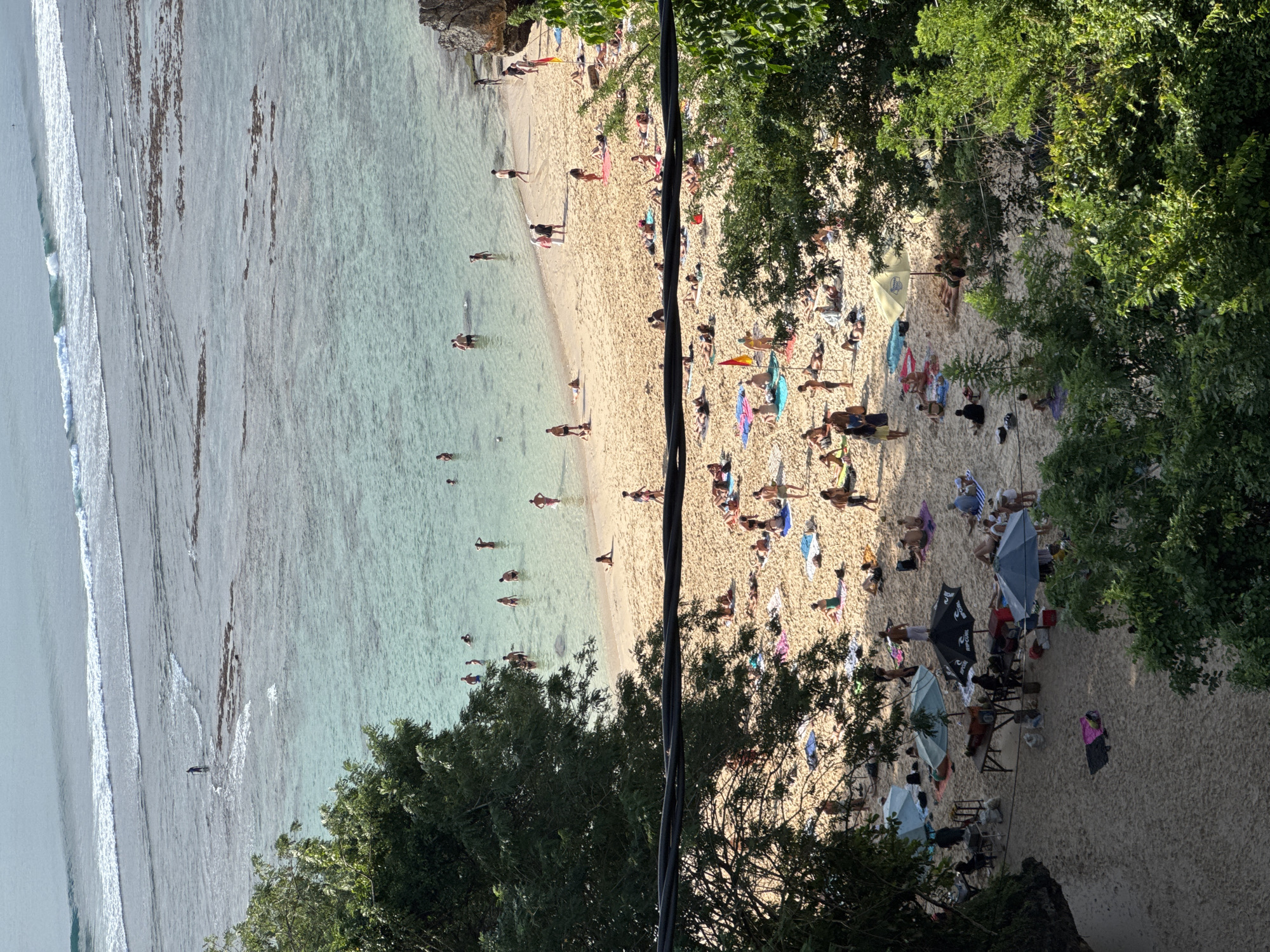 Morning beach crowds and street life observed in Kuta Selatan