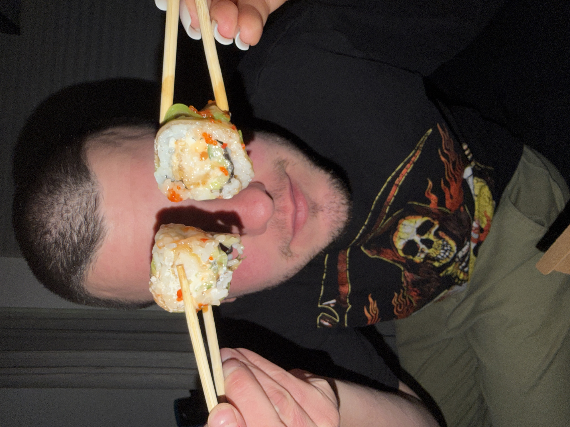 Man playfully eats takeout sushi in Varna, Bulgaria