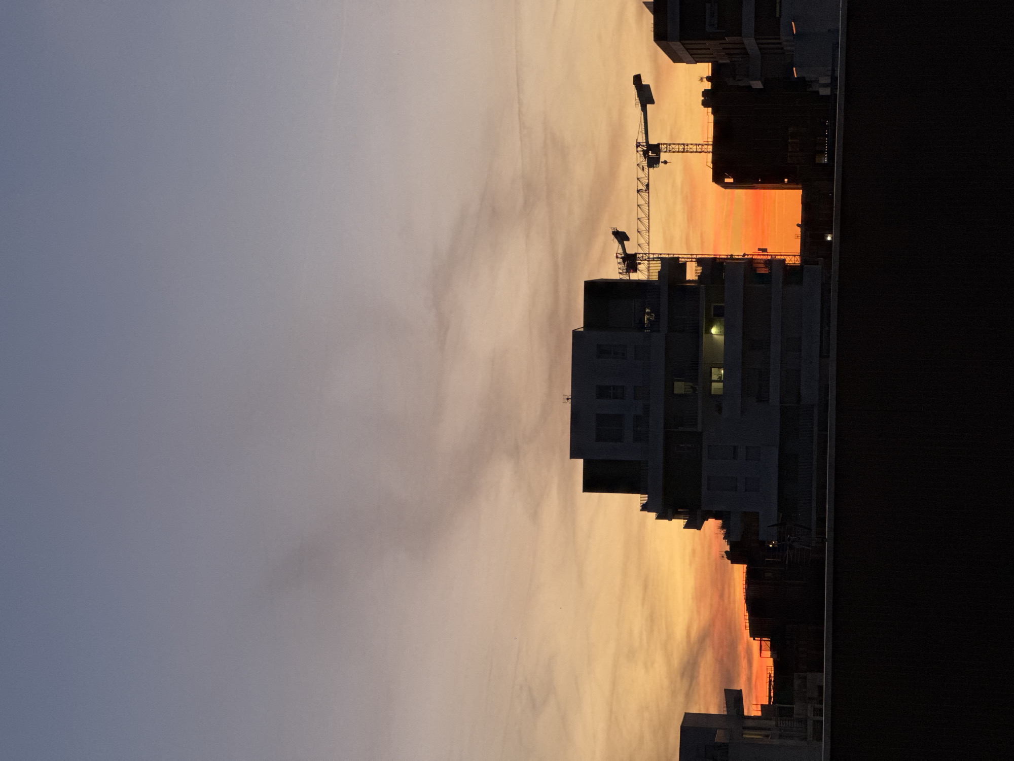 Sunset observed over Toulouse cityscape with contrails May 23