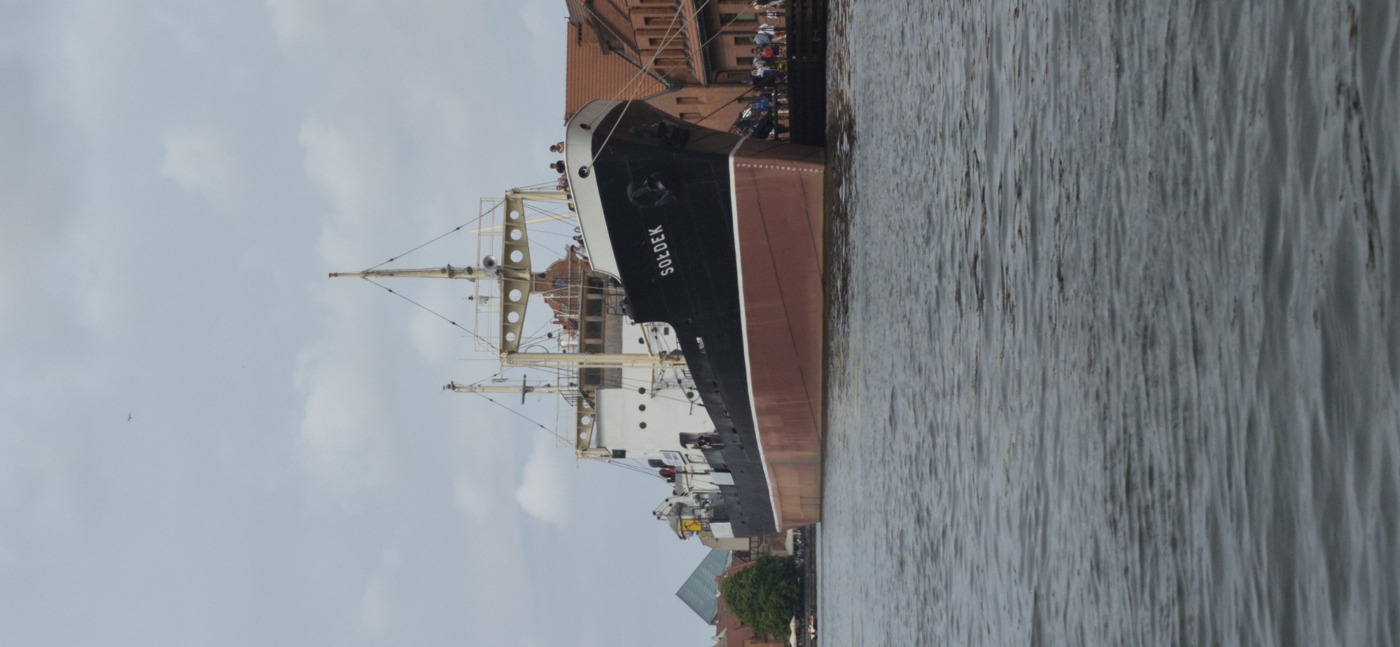 Gdańsk's Motława waterfront: tall ships, old town facades, kayakers