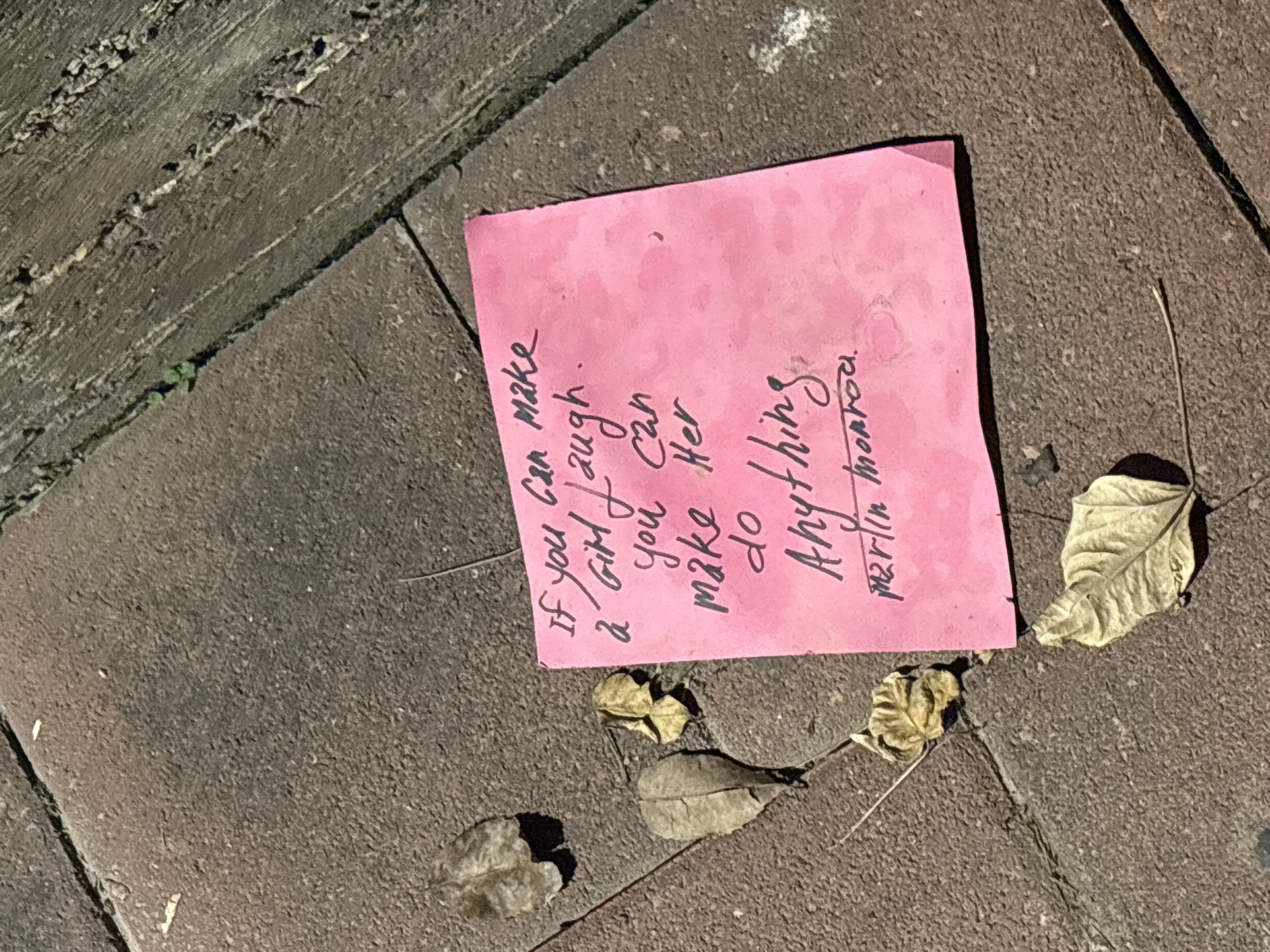 Pink sticky note with Marilyn Monroe quote found on Israeli sidewalk