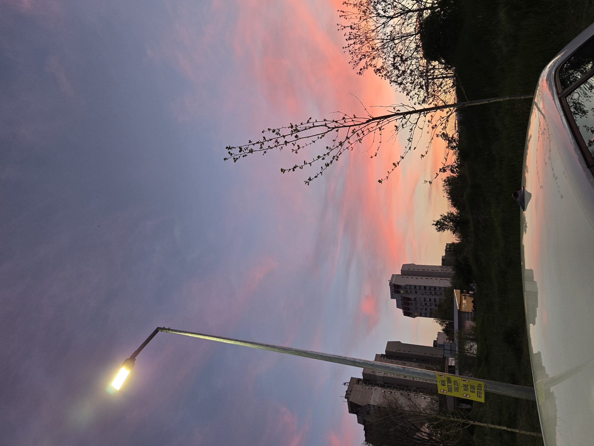 Urban sunset documented with dramatic sky colors and vehicle