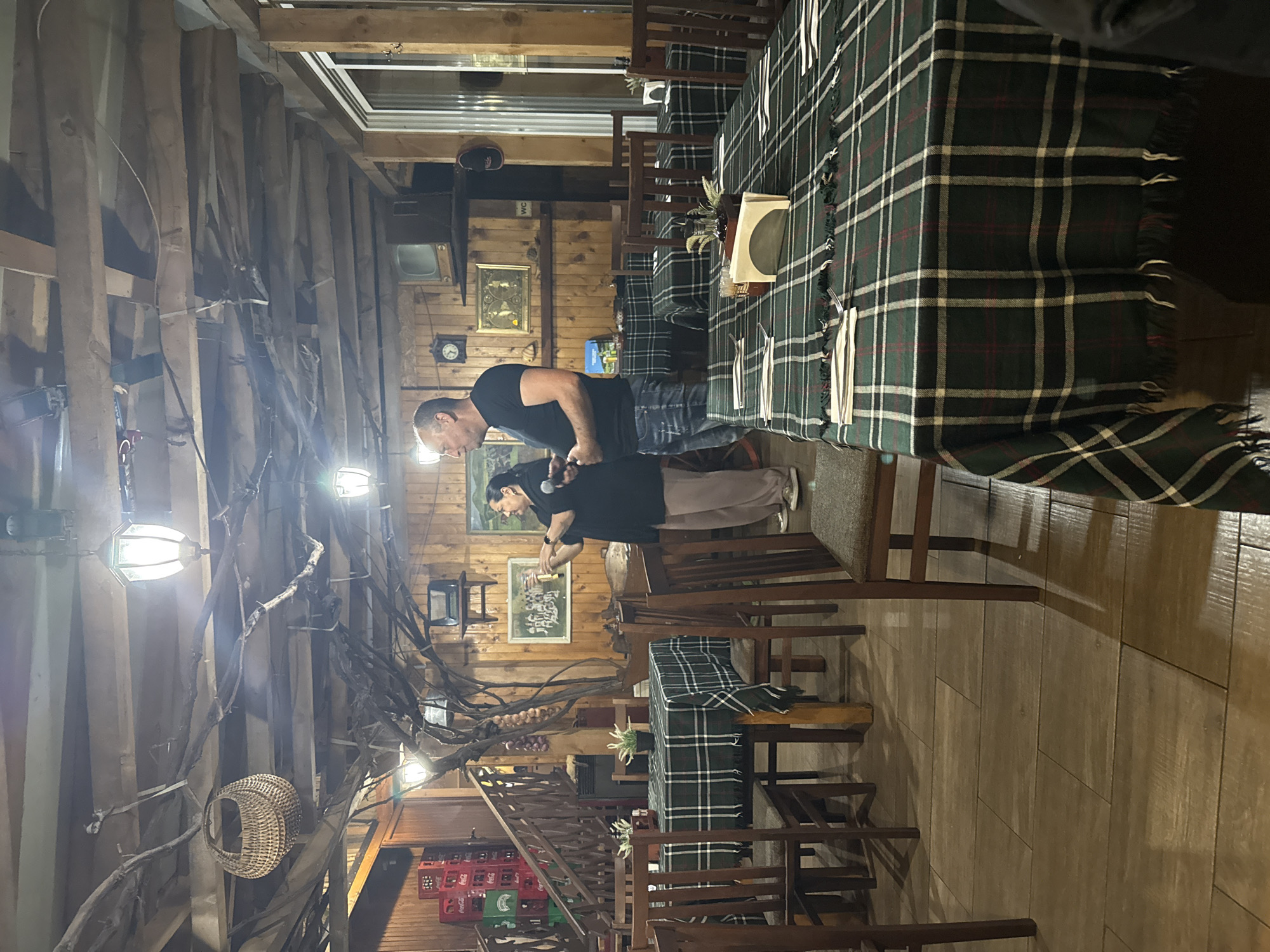 Duo performs at rustic restaurant with wooden beam decor