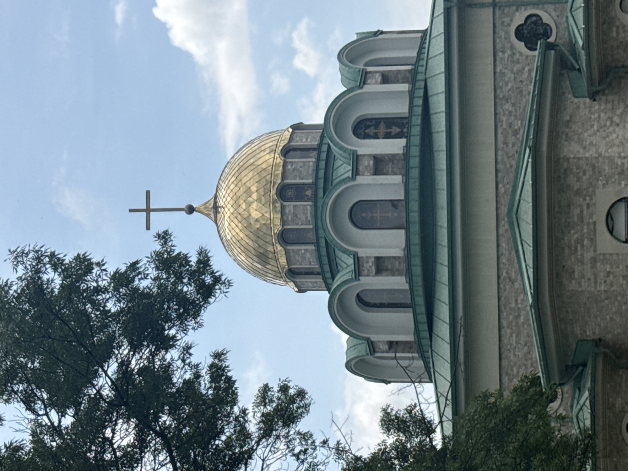 Woman photographed near golden-domed church in Burgas, Bulgaria