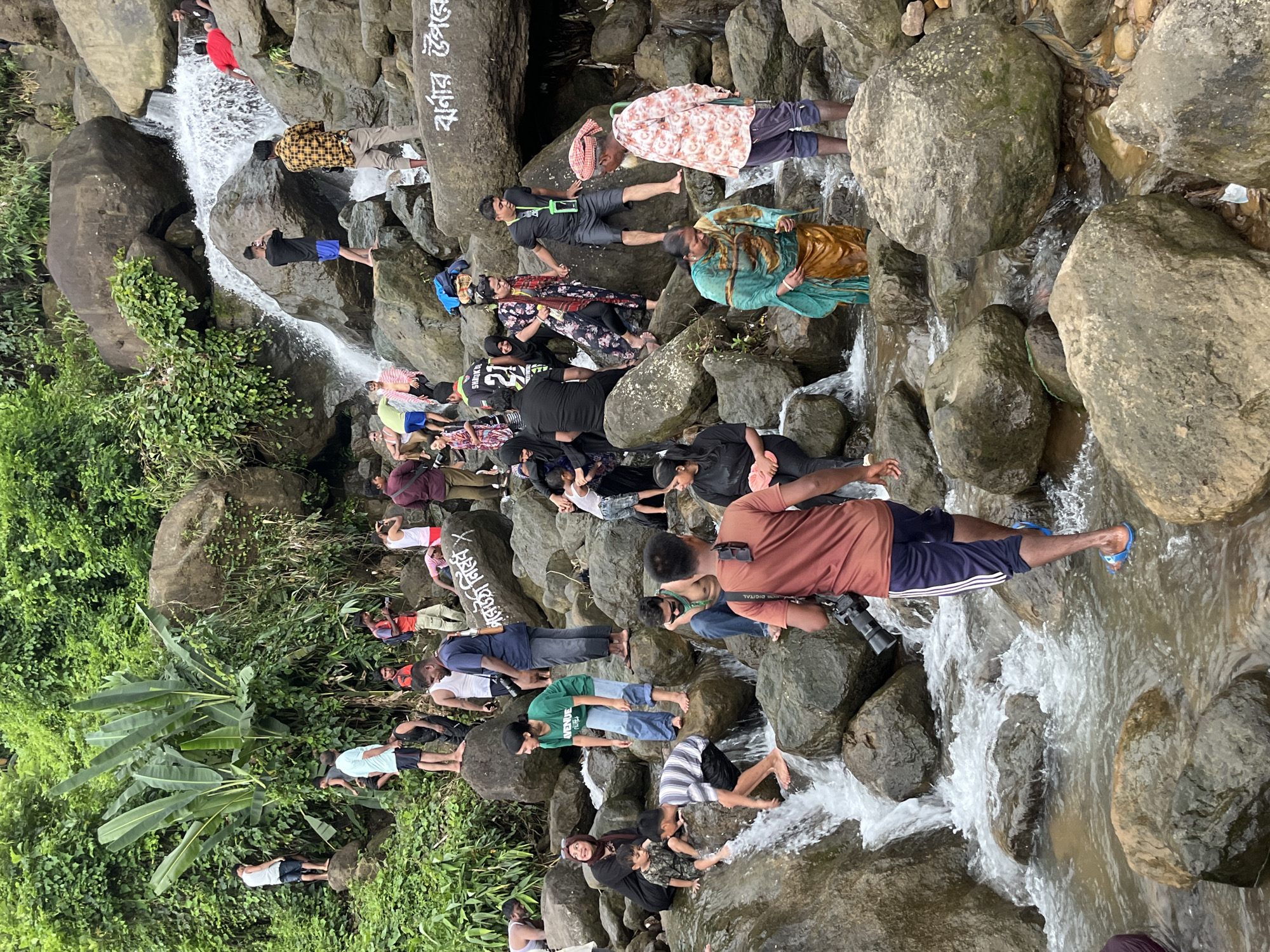Crowds enjoy the rocky waterfall at Jaflong, Bangladesh