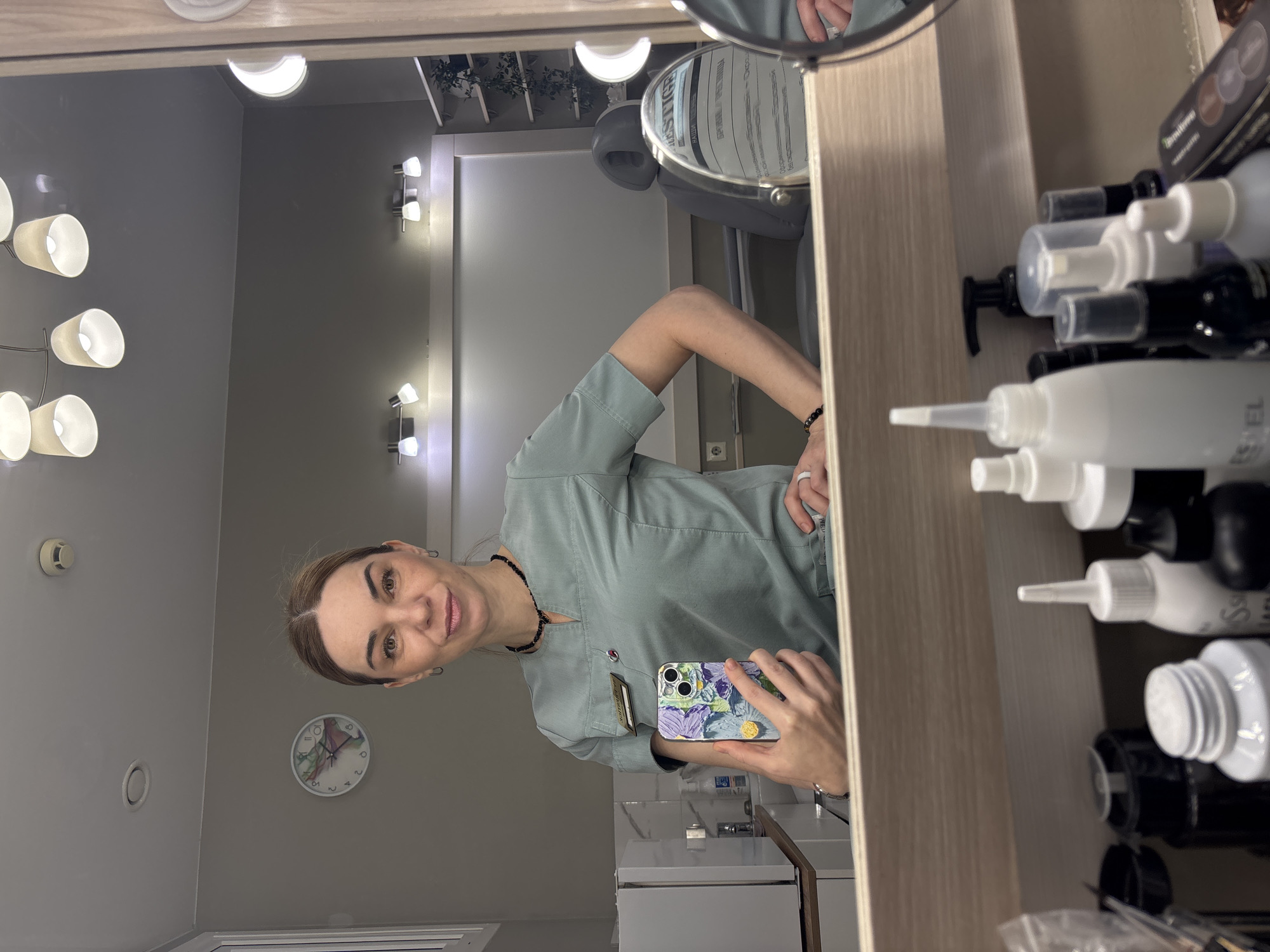 Healthcare worker documents shift with mirror selfies in scrubs