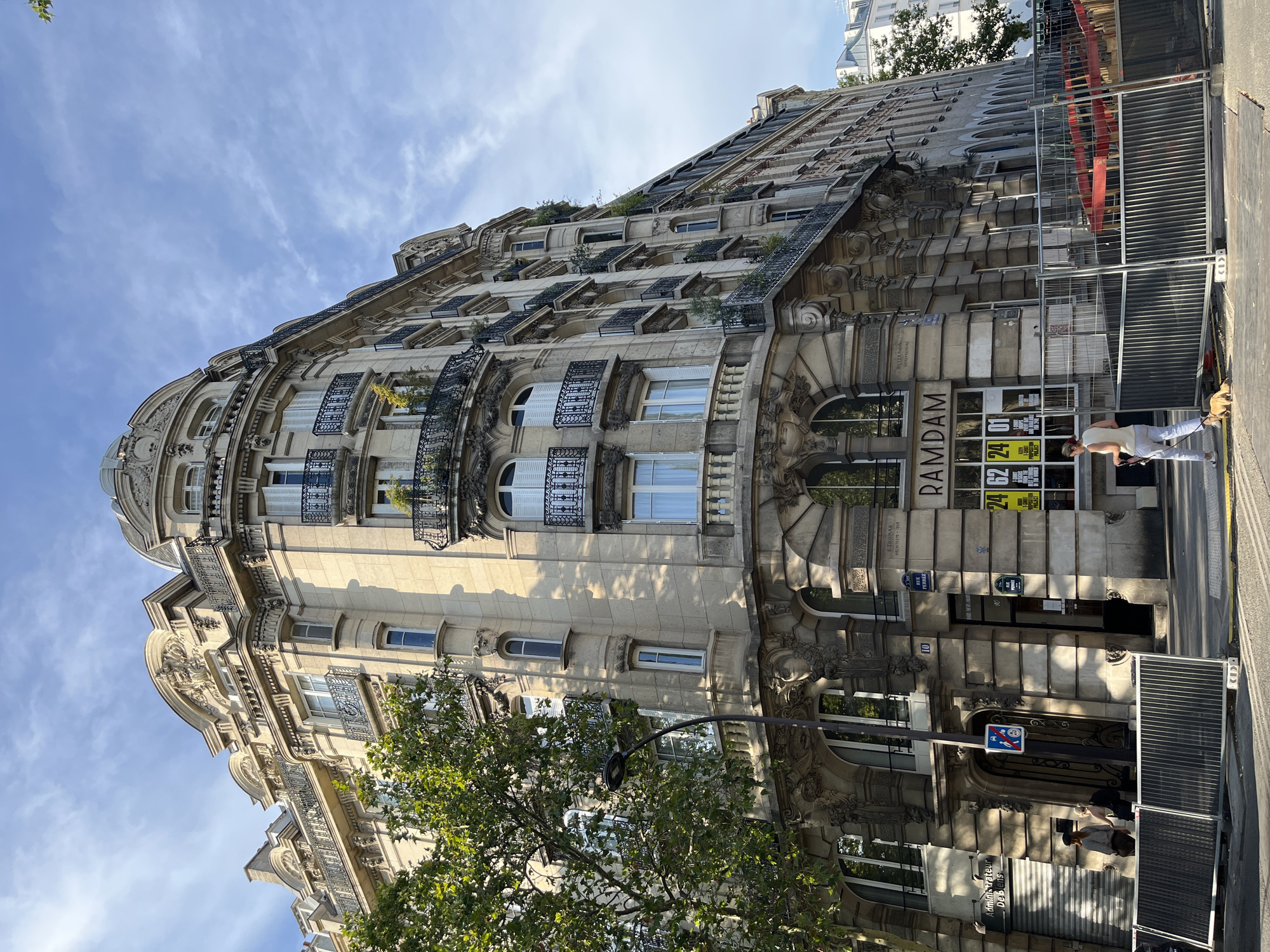 Haussmannian Paris facades, one dressed in a mandala mural