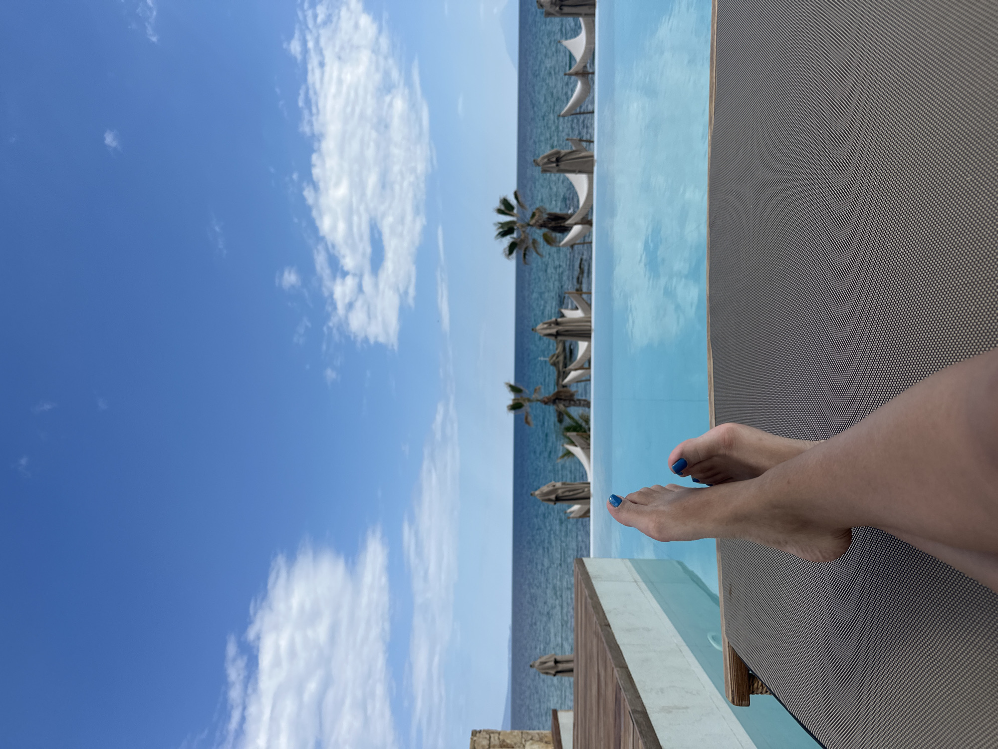 Pool day leisure time captured at Greek infinity pool